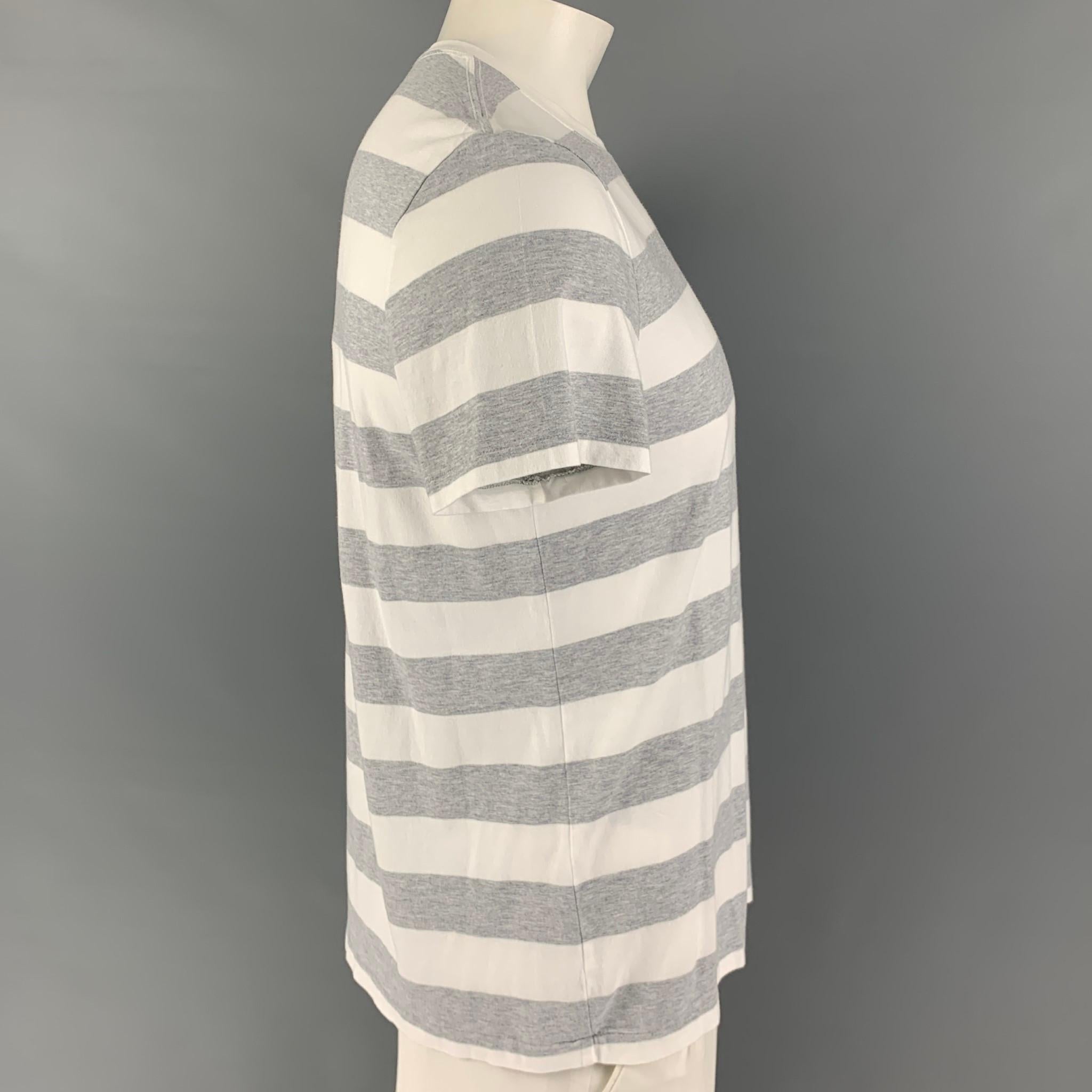 BURBERRY BRIT t-shirt comes in a white & grey stripe cotton featuring a patch pocket, embroidered logo, and a crew-neck. 

Excellent Pre-Owned Condition.
Marked: L

Measurements:

Shoulder: 17.5 in.
Chest: 42 in.
Sleeve: 8.5 in.
Length: 27.5 in.