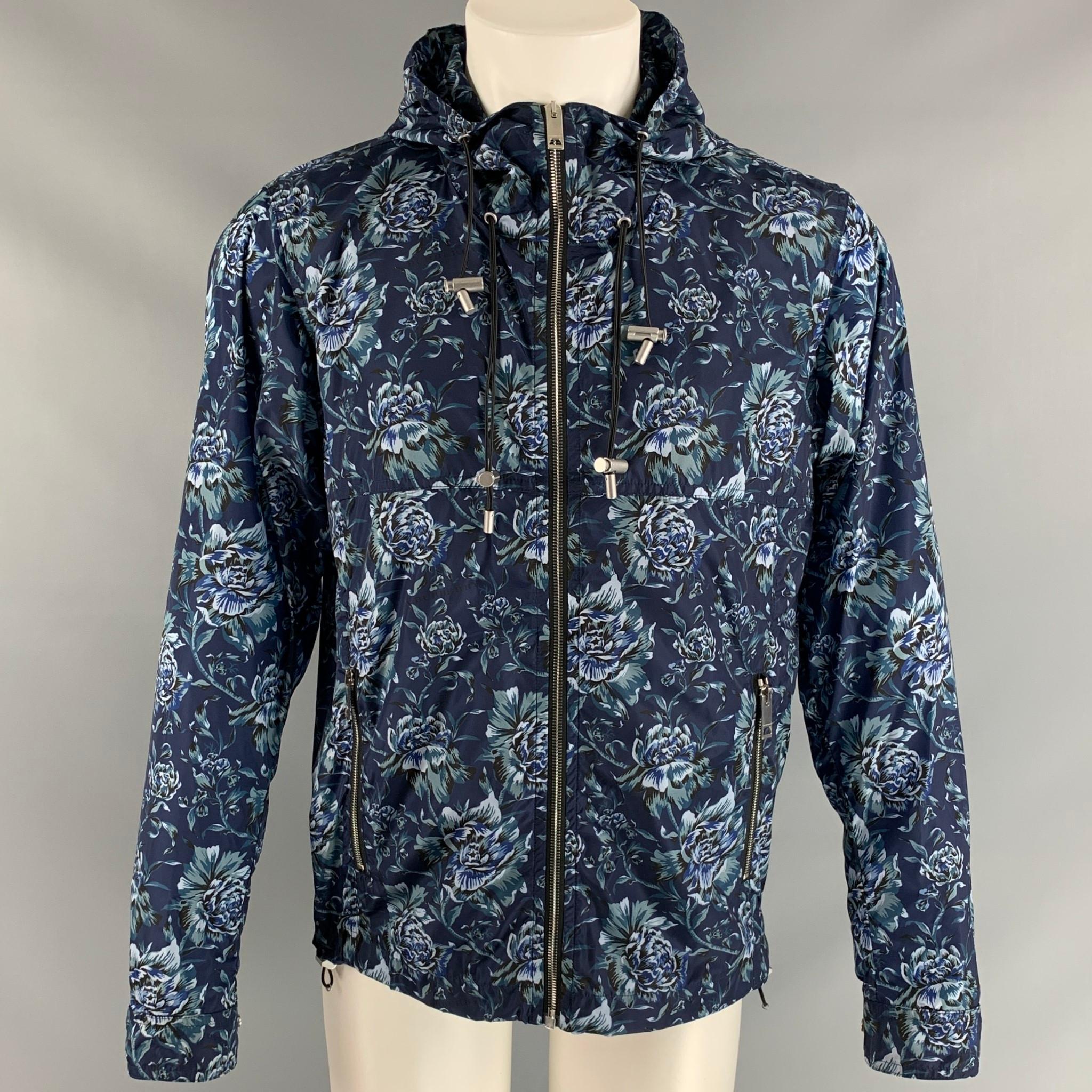 BURBERRY windbreaker jacket, half lined in the same material comes in blue floral nylon featuring a zipper closure at center front, two zipper pockets at front, hood and adjustable metal hardware. Made in Italy.

New with Tags.
Marked:
