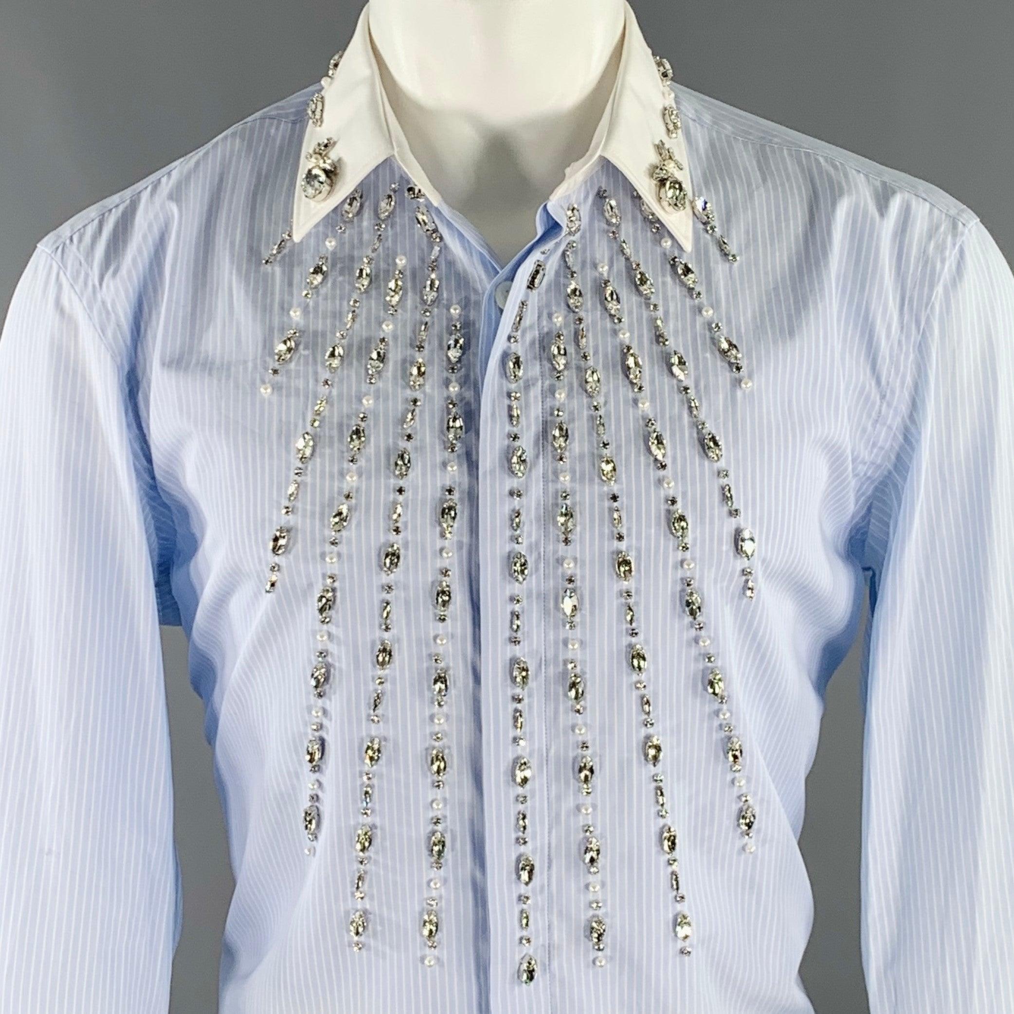 BURBERRY long sleeve shirt
in a blue and white cotton woven fabric featuring a pinstripe pattern, contrasting white collar and cuffs, rhinestone and faux pearl embellished front, and hidden button closure. Made in Italy.Very Good Pre-Owned Condition
