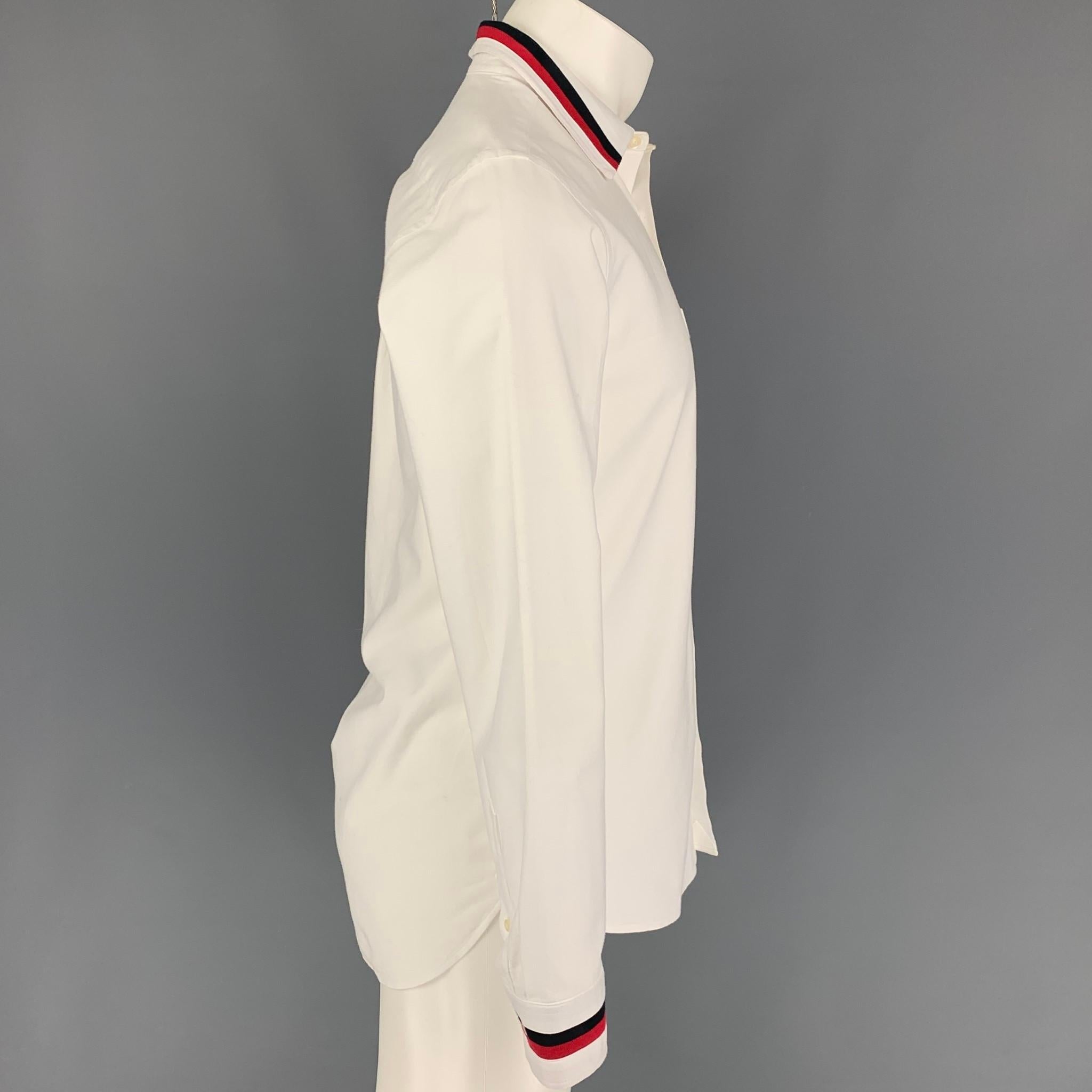 BURBERRY long sleeve shirt comes in a white cotton featuring a stripe trim, spread collar, patch pocket, and a button up closure. 

Good Pre-Owned Condition. Minor discoloration at sleeve and collar.
Marked: S

Measurements:

Shoulder: 17.5
