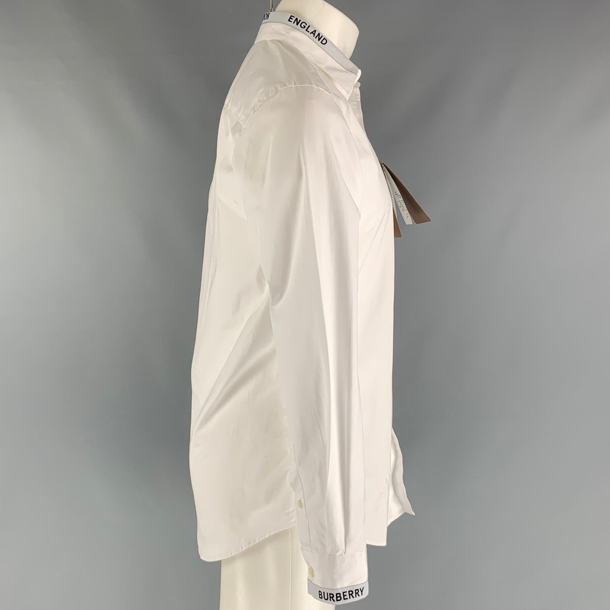 Burberry by Ricardo Tisci long sleeve shirt comes in a white cotton featuring straight collar, Burberry London trim at collar and sleeve cuffs, and buttons closure. Made in Portugal.Very Good Pre-Owned Condition. With Tags. Moderate marks. 

Marked: