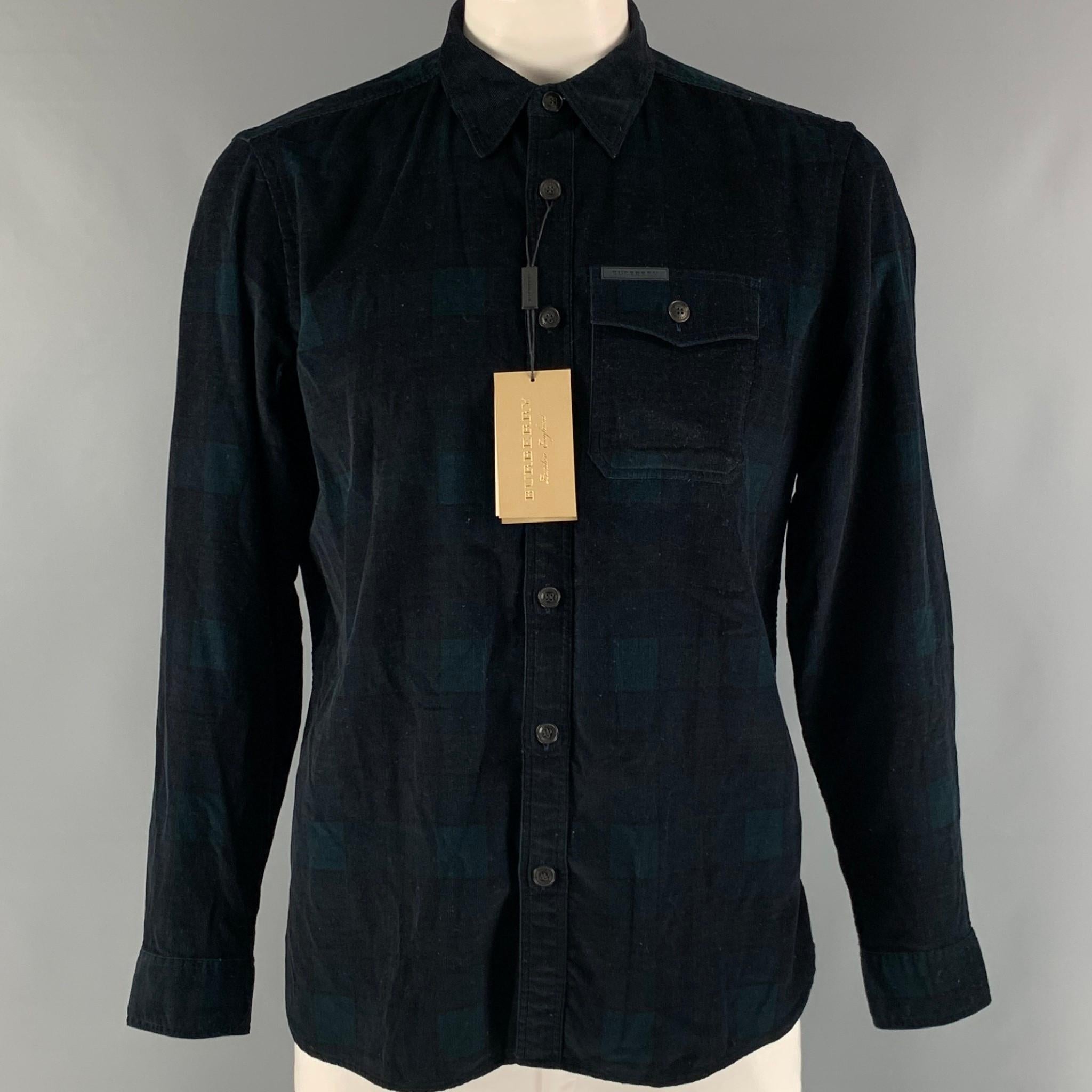 BURBERRY 'GOSHA RUBCHINSKIY' long sleeve shirt comes in a green and navy blackwatch plaid cotton corduroy material featuring front pockets, straight collar, and a button up closure. Made in Italy.

New with Tags.
Marked: XL

Measurements:

Shoulder: