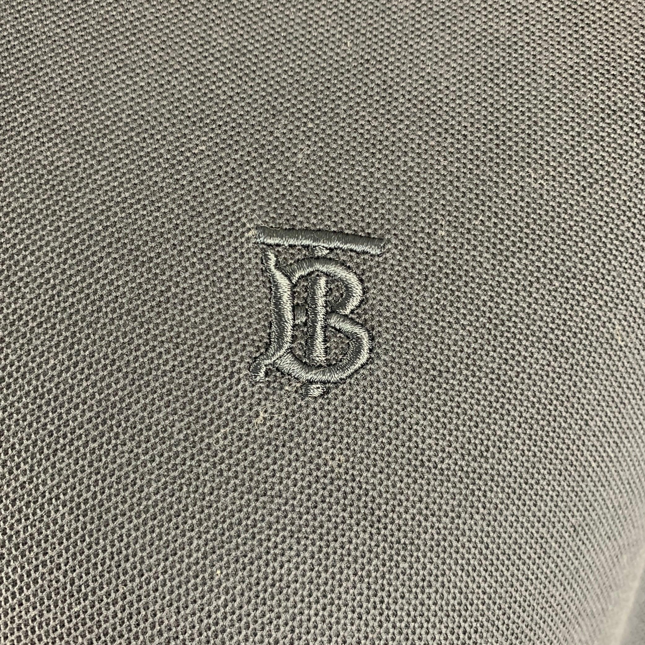 BURBERRY polo
in a navy
cotton knit featuring embroidered Burberry monogram, spread collar, and half placket button closure with signature Burberry plaid trim.Excellent Pre-Owned Condition. 

Marked:   XXL 

Measurements: 
 
Shoulder: 19 inches