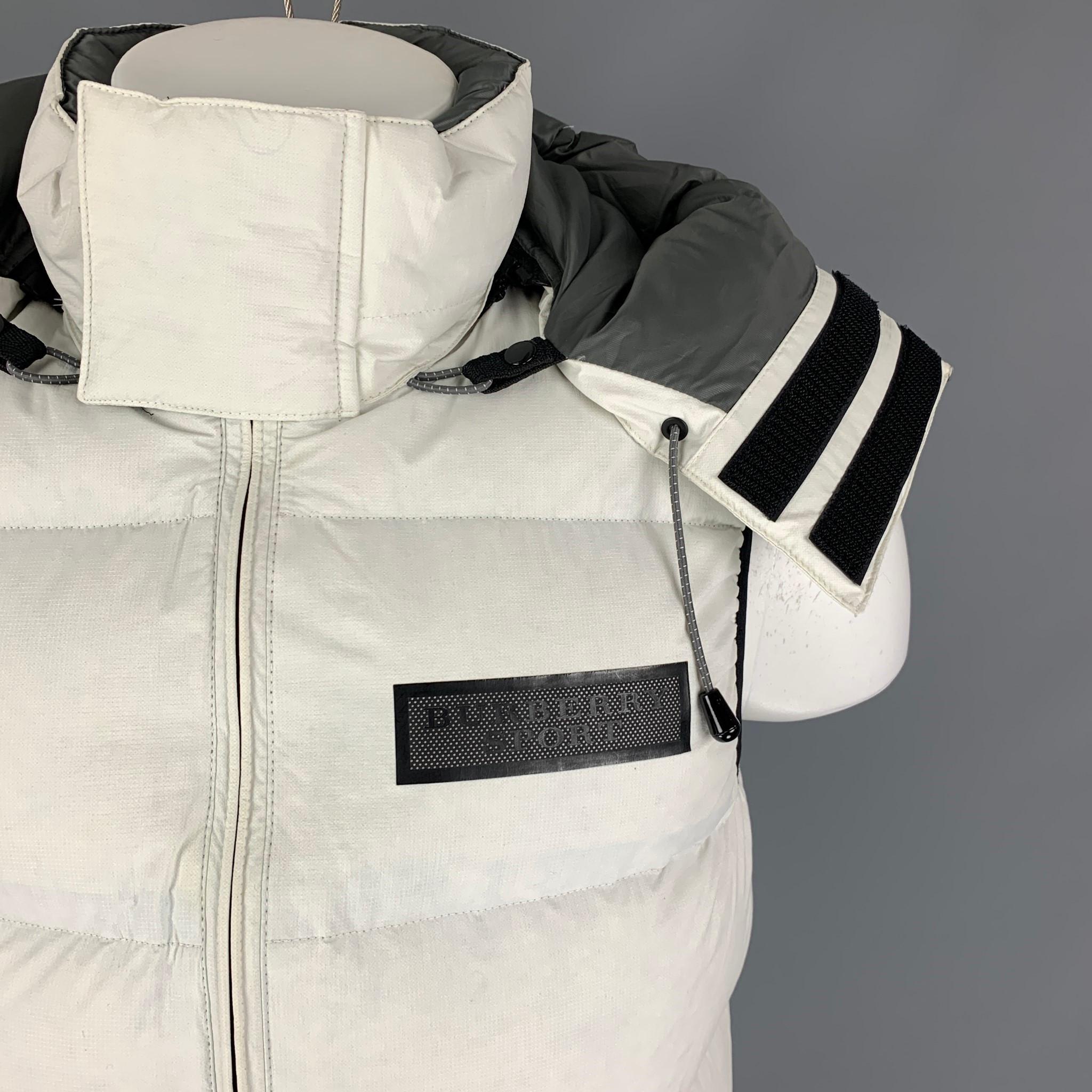 BURBERRY SPORT puffer vest comes in a off white quilted polyamide with duck down featuring a detachable hood, black contrast trim, front zipper pockets, and a full zip up closure. 

Very Good Pre-Owned Condition.
Marked: M

Measurements:

Shoulder: