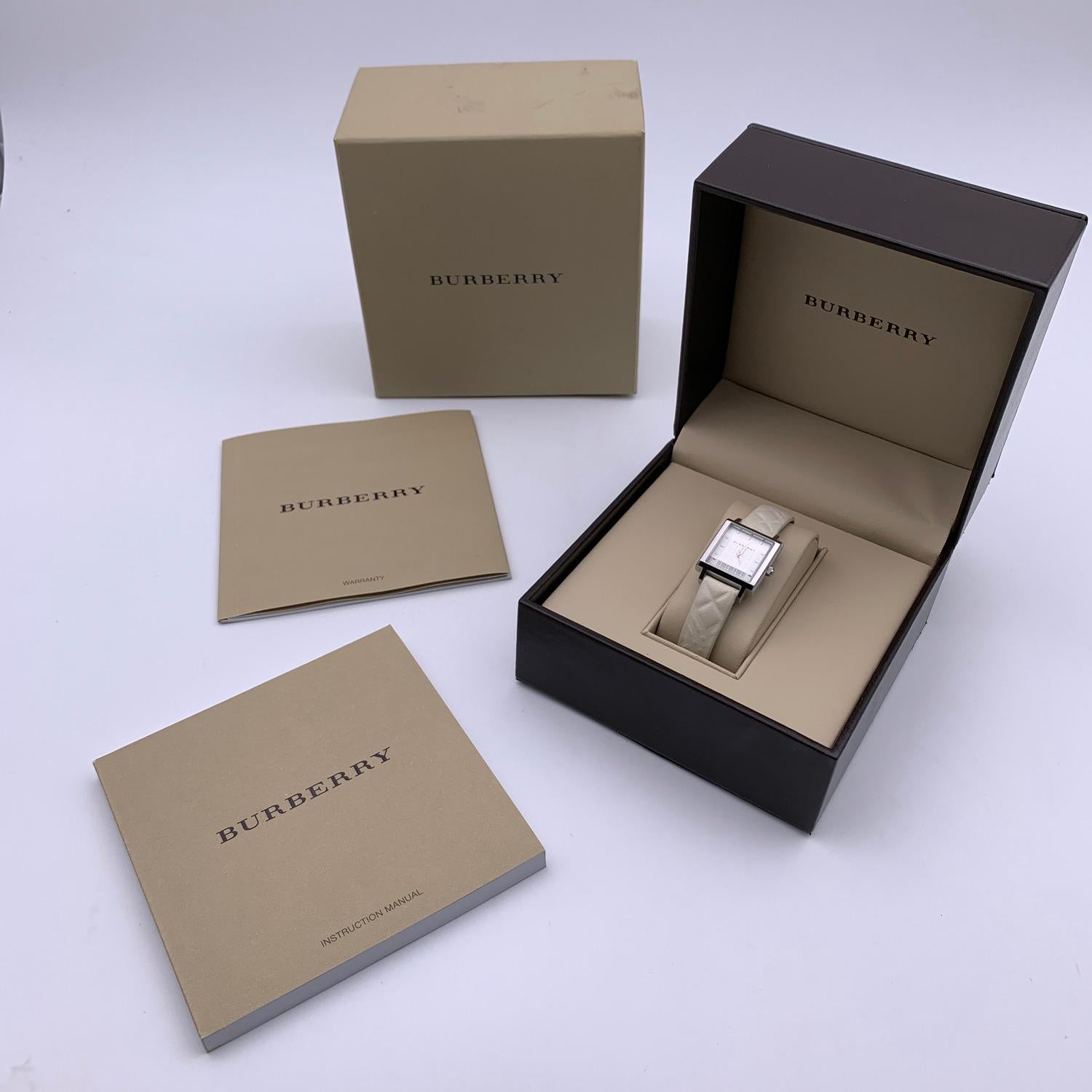 Beautiful Burberry Watch, mod. BU2002. Stainless steel case and white dial. Sapphire scratch resistant crystal. Silver-tone hands. Beige leather wrist strap with buckle closure. 18 holes adjustment. Swiss made quartz movement. Waterproof up to 3