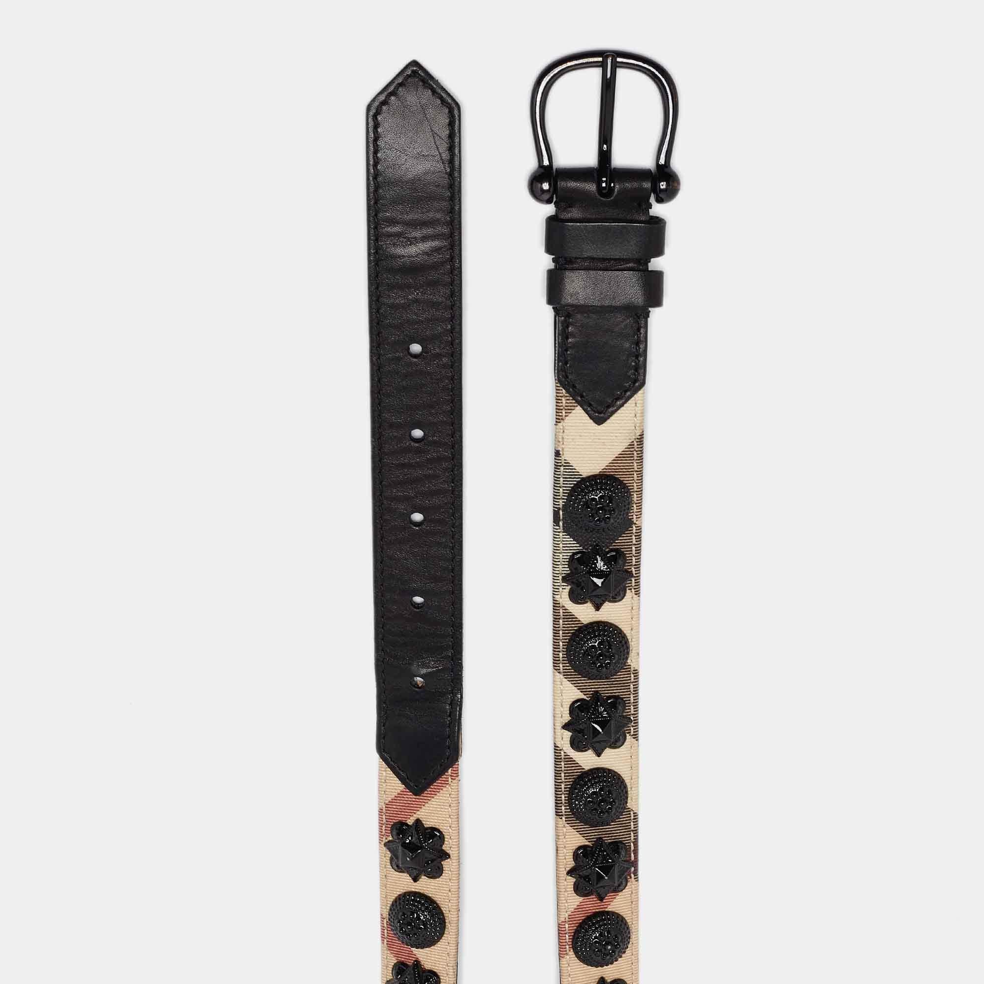 This belt from Burberry is made from the classic Supernova check PVC and leather. The beige and black belt has black tone embellishments carefully placed on it. It carries a simple pin buckle closure and can add extra style to any outfit.