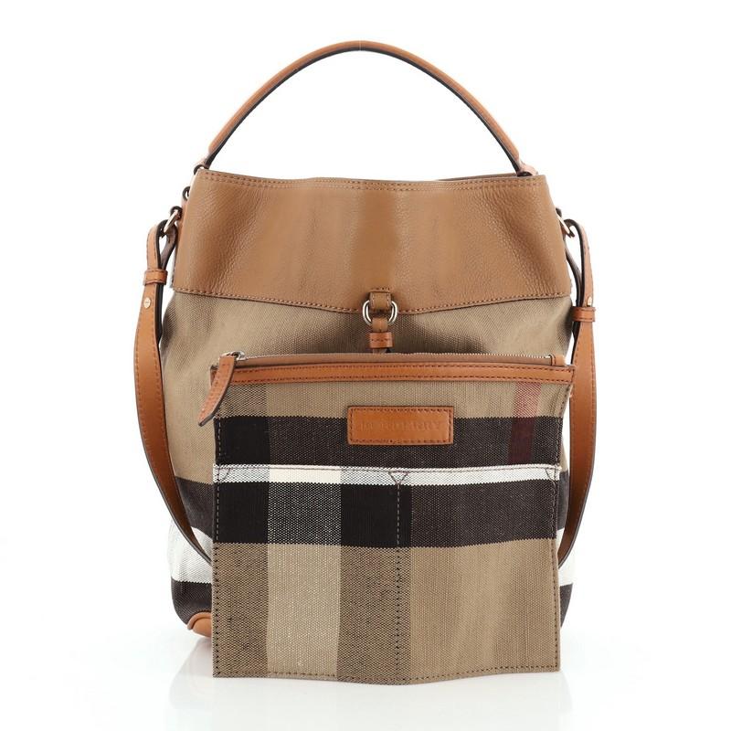 This Burberry Susanna Tassel Hobo House Check Canvas Medium, crafted in brown leather with Burberry's iconic house check canvas, features a simple bucket-style silhouette, tassel details, single looped top handle and gold-tone hardware. Its hook