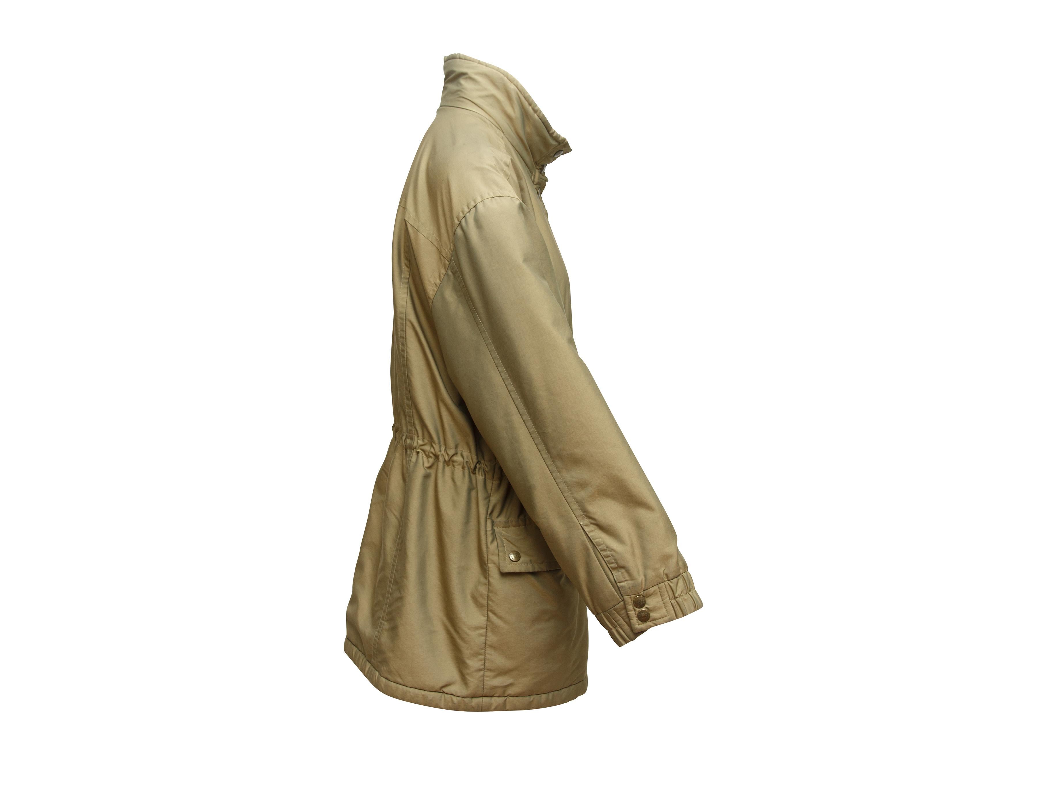Product details: Vintage tan fleece-lined jacket by Burberry. Dual pockets at hips. Snap closures at front. 41