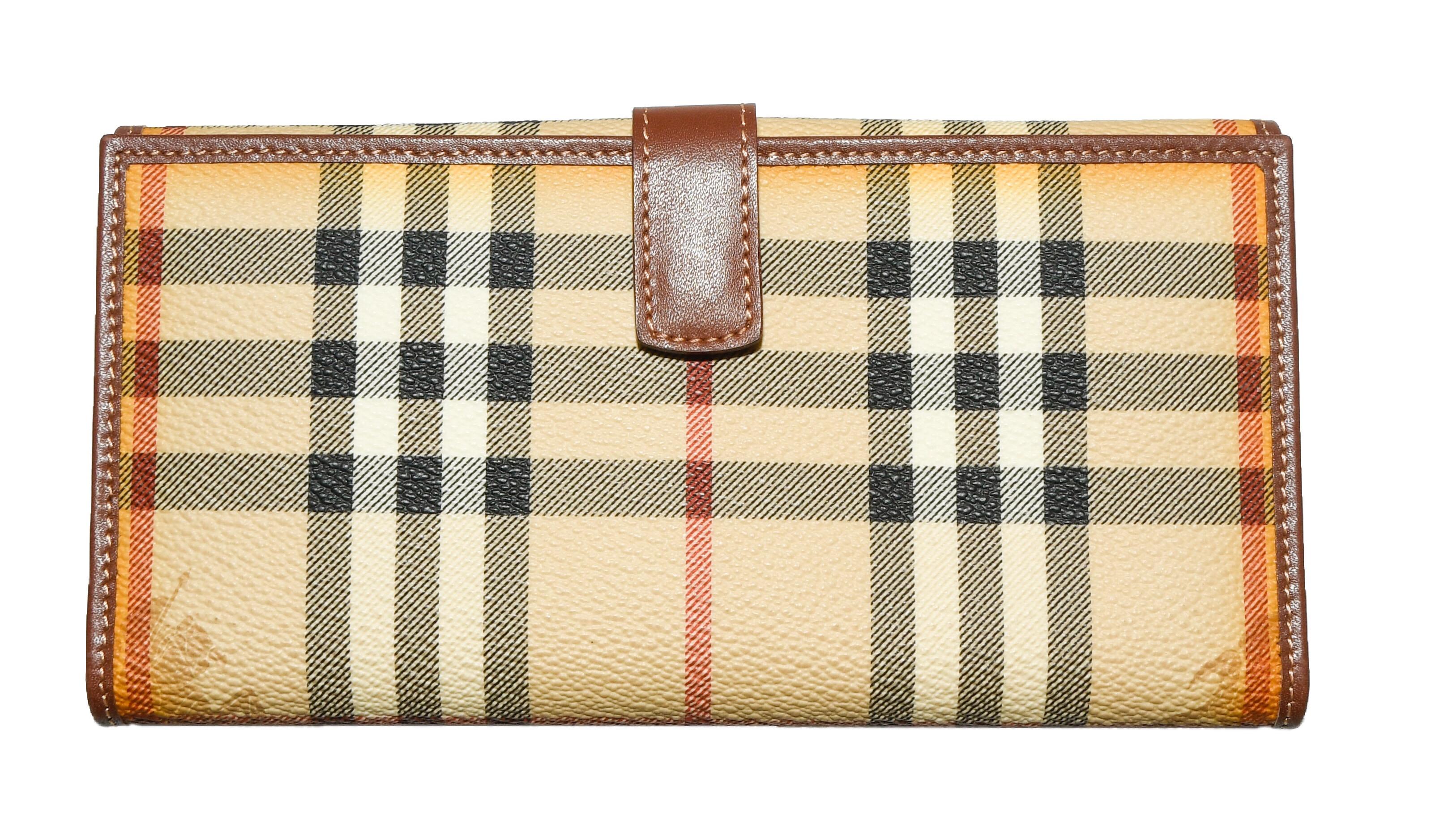 Burberry luxurious addition to your accessories repertoire, the Burberry Prorsum vintage wallet is designed in the label's signature House plaid check in a nod to its rich British heritage.   This wallet can hold all of your essentials, it boasts