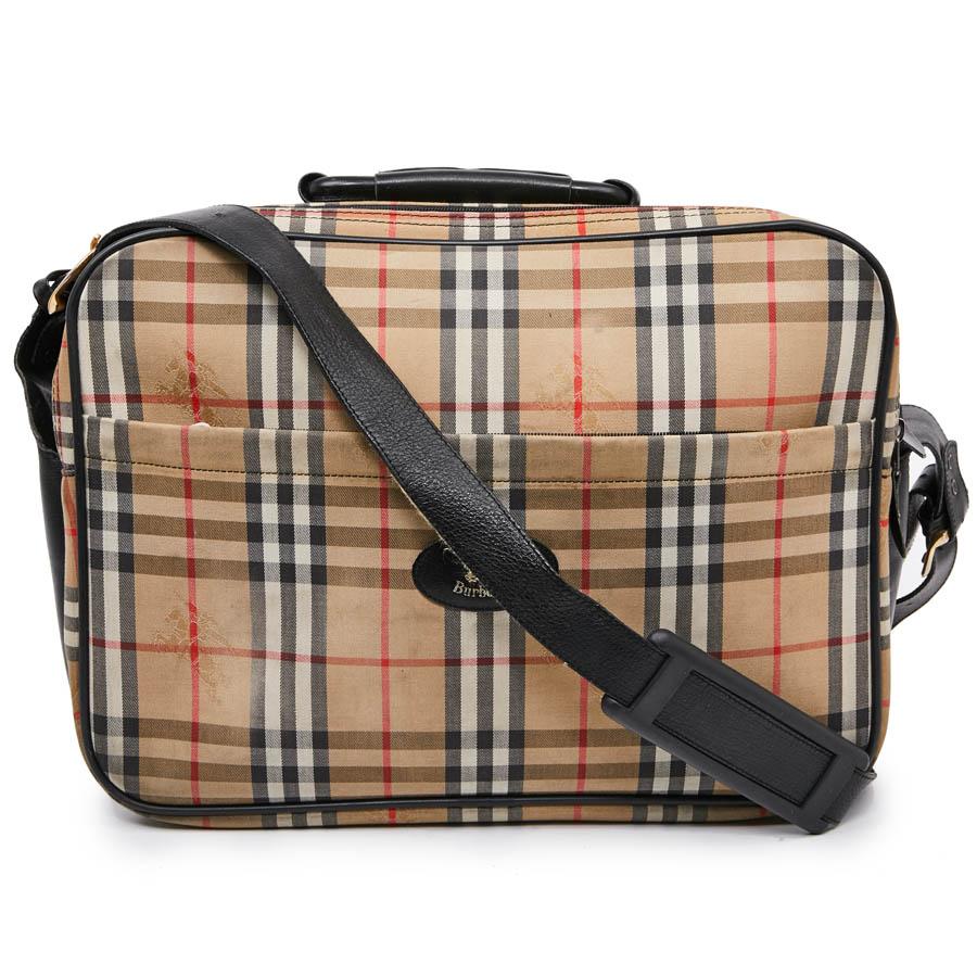 This BURBERRY weekend bag can also be used as briefcase and computer. It is beige tartan monogram canvas. Very practical with 3 large storage pockets, and a smaller one also zipped. The interior is leather and black canvas. It is worn by hand or on