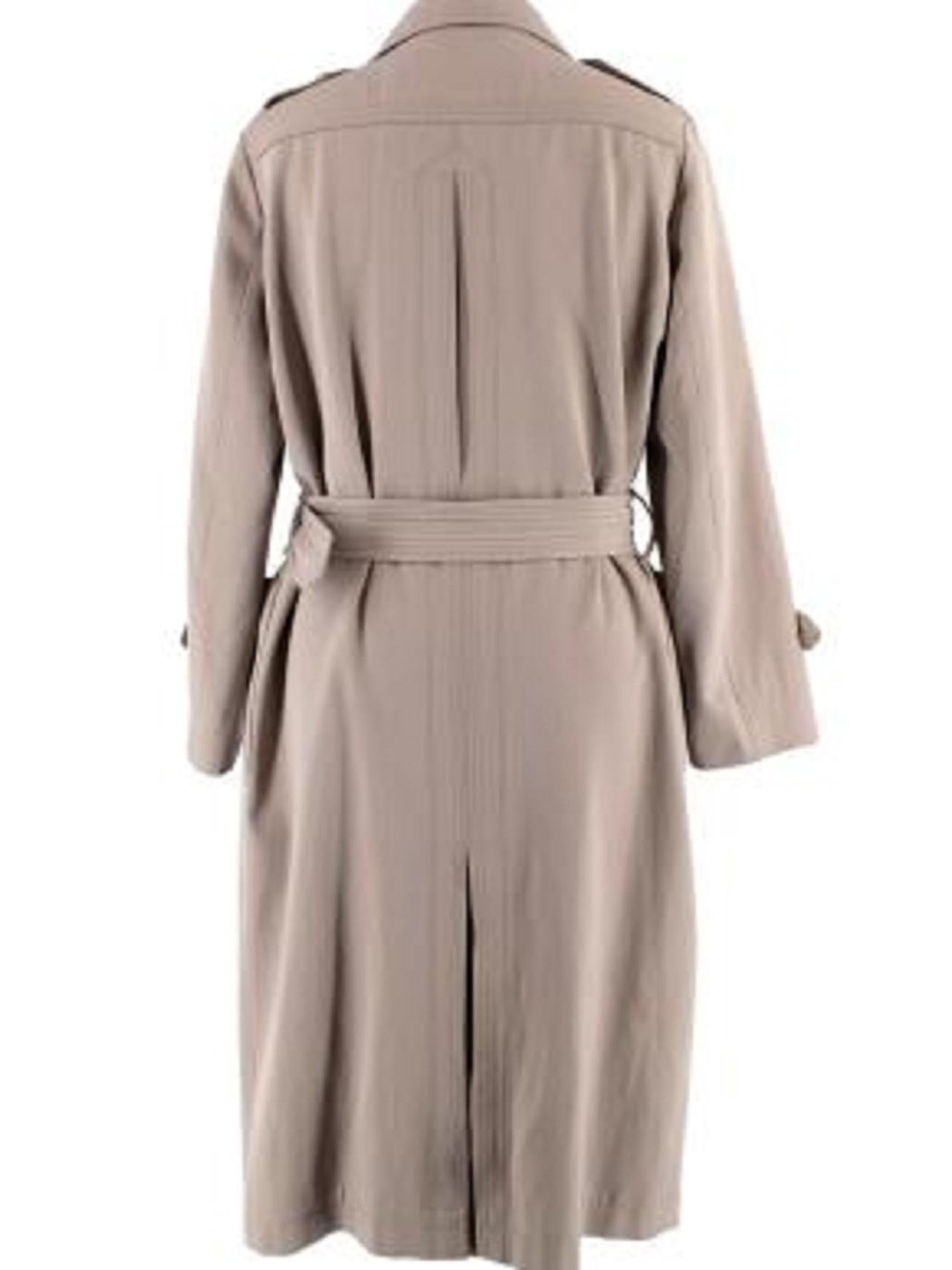 Burberry Taupe Wool-Blend Trench Coat

- Wool and cotton blend taupe double-breasted trench coat with belt 
- 2 large side patch pockets 
- Black leather belt buckle 
- Partially satin lined 
- Button trim on the sleeve cuffs and shoulders 
-