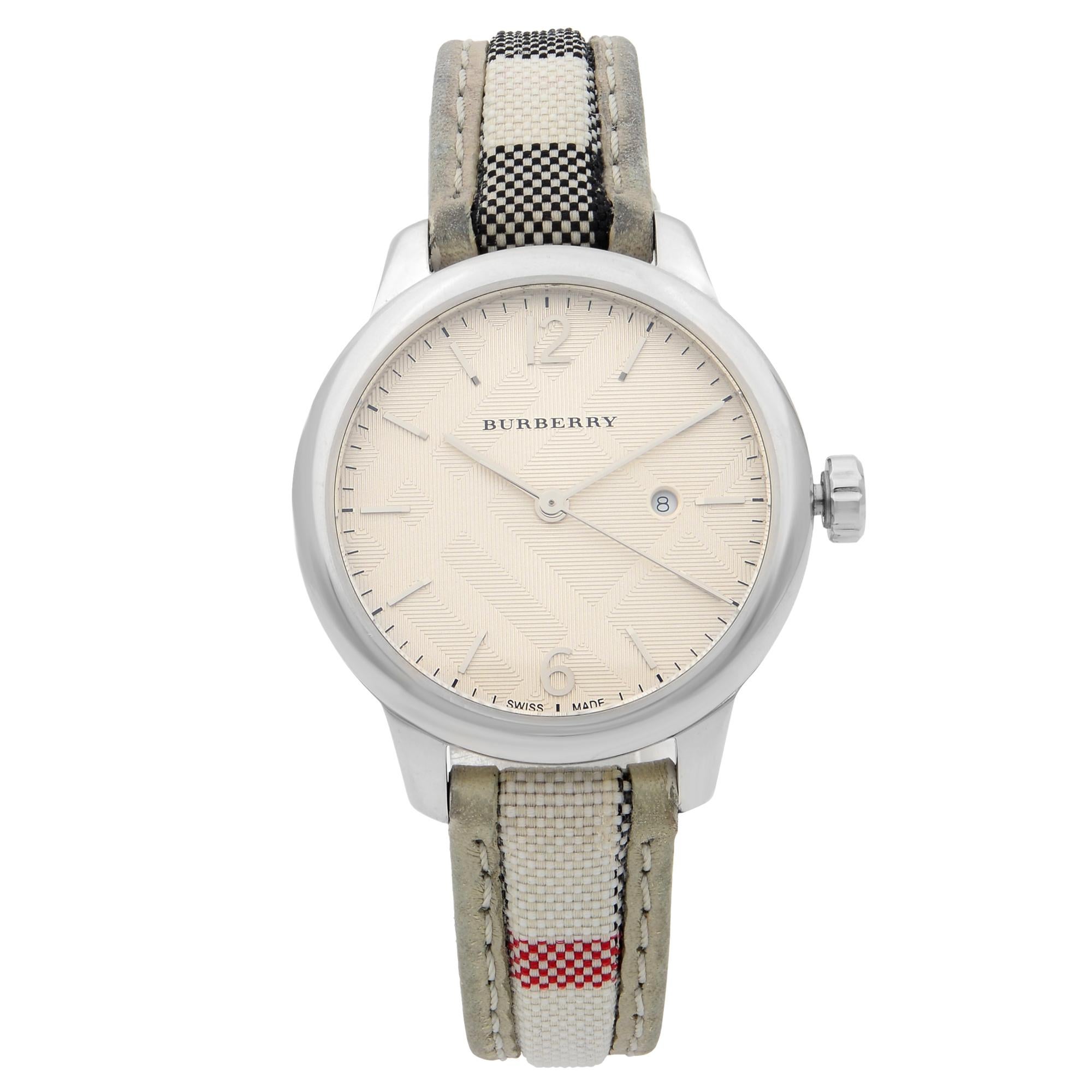 This pre-owned Burberry The Classic  BU10113 is a beautiful Ladie's timepiece that is powered by quartz (battery) movement which is cased in a stainless steel case. It has a round shape face, date indicator dial and has hand sticks & numerals style