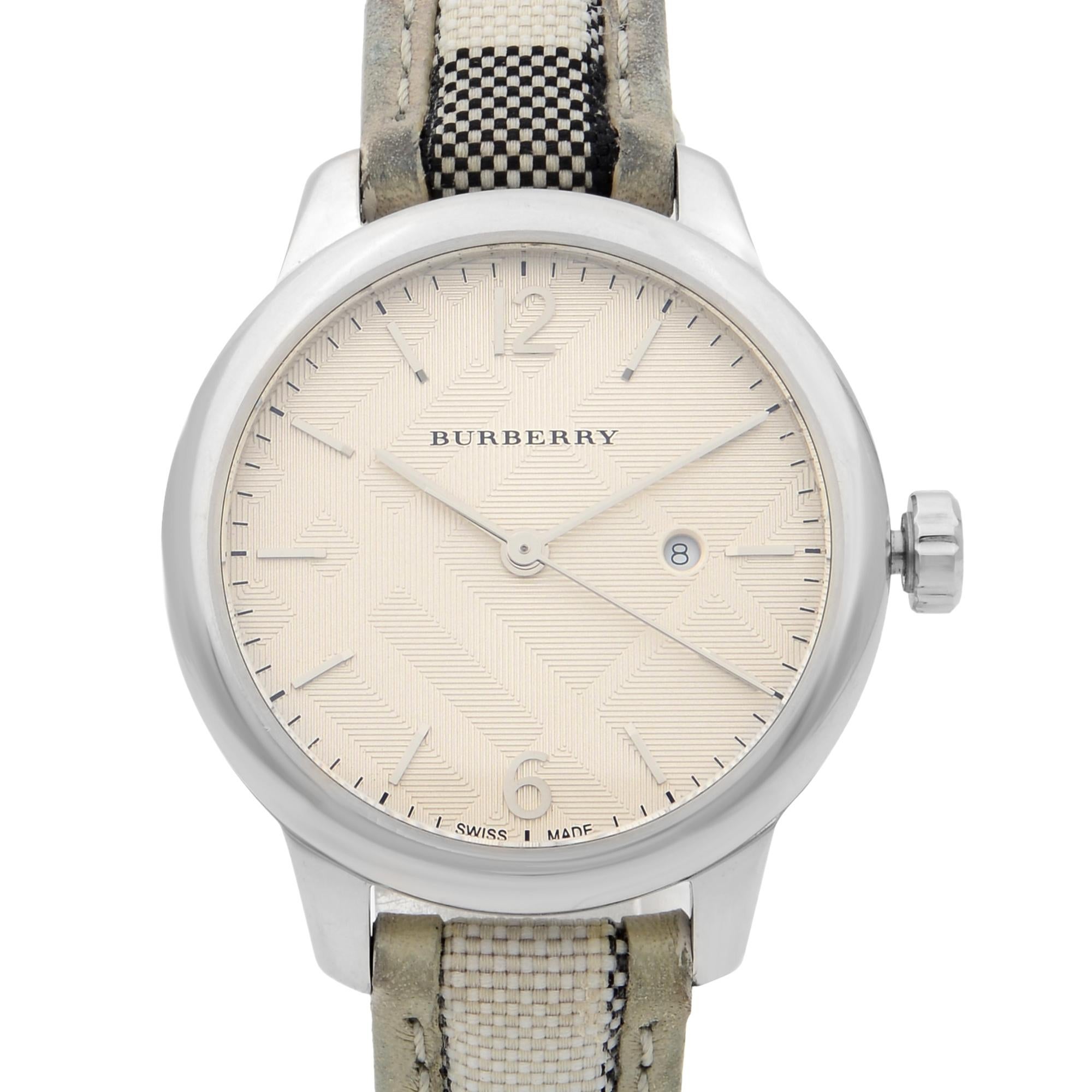 This pre-owned Burberry The Classic  BU10113 is a beautiful Ladie's timepiece that is powered by quartz (battery) movement which is cased in a stainless steel case. It has a round shape face, date indicator dial and has hand sticks & numerals style