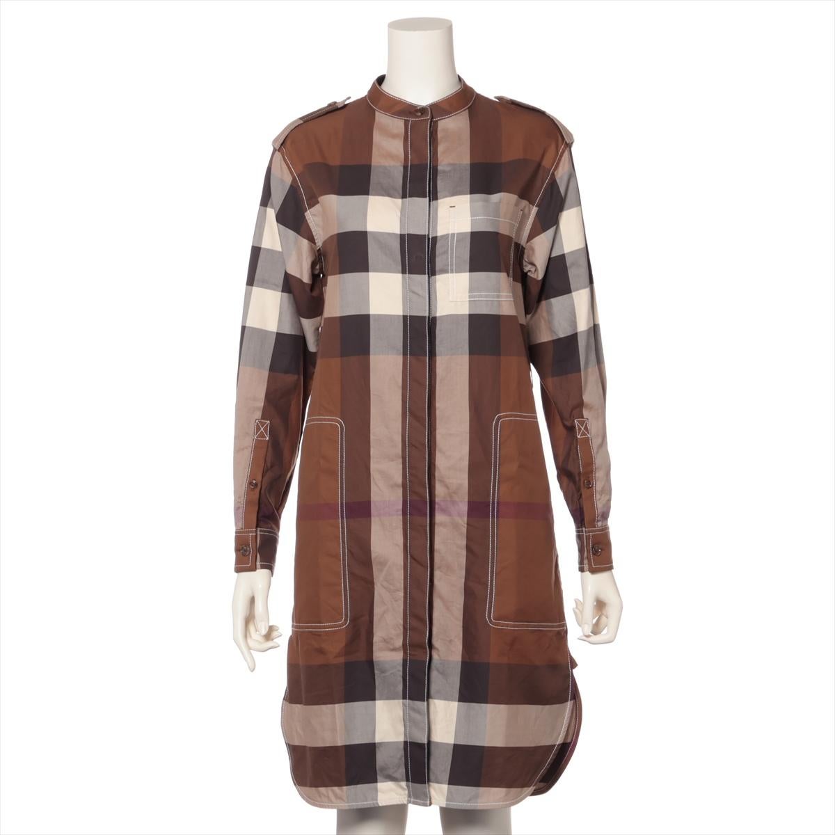 The Burberry Tisci Period Long Sleeve Cotton Dress in brown check is a stylish blend of heritage and modern design. Crafted from premium cotton, the dress features Burberry's iconic check pattern in a warm brown hue, offering a contemporary twist on