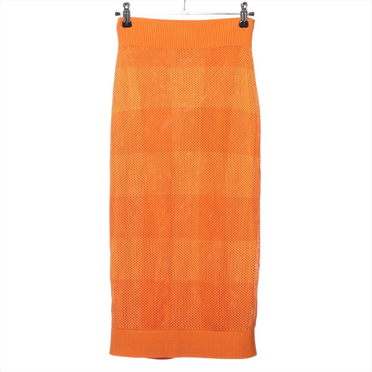 The Burberry Tisci Period Cuprammonium Rayon Knit Long Skirt in Orange is a striking and sophisticated piece that blends luxury with modern design. Made from soft see-through and cuprammonium rayon, the long knit skirt drapes elegantly, offering a
