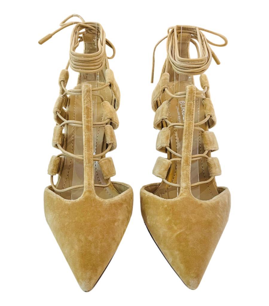 Burberry Velvet Strappy Heels
Beige pumps designed with lace-up detail to the vamp and around the ankle.
Featuring pointed toe and stiletto heel.
Size – 37
Condition – Very Good
Composition – Velvet
Comes with – Shoes Only 

