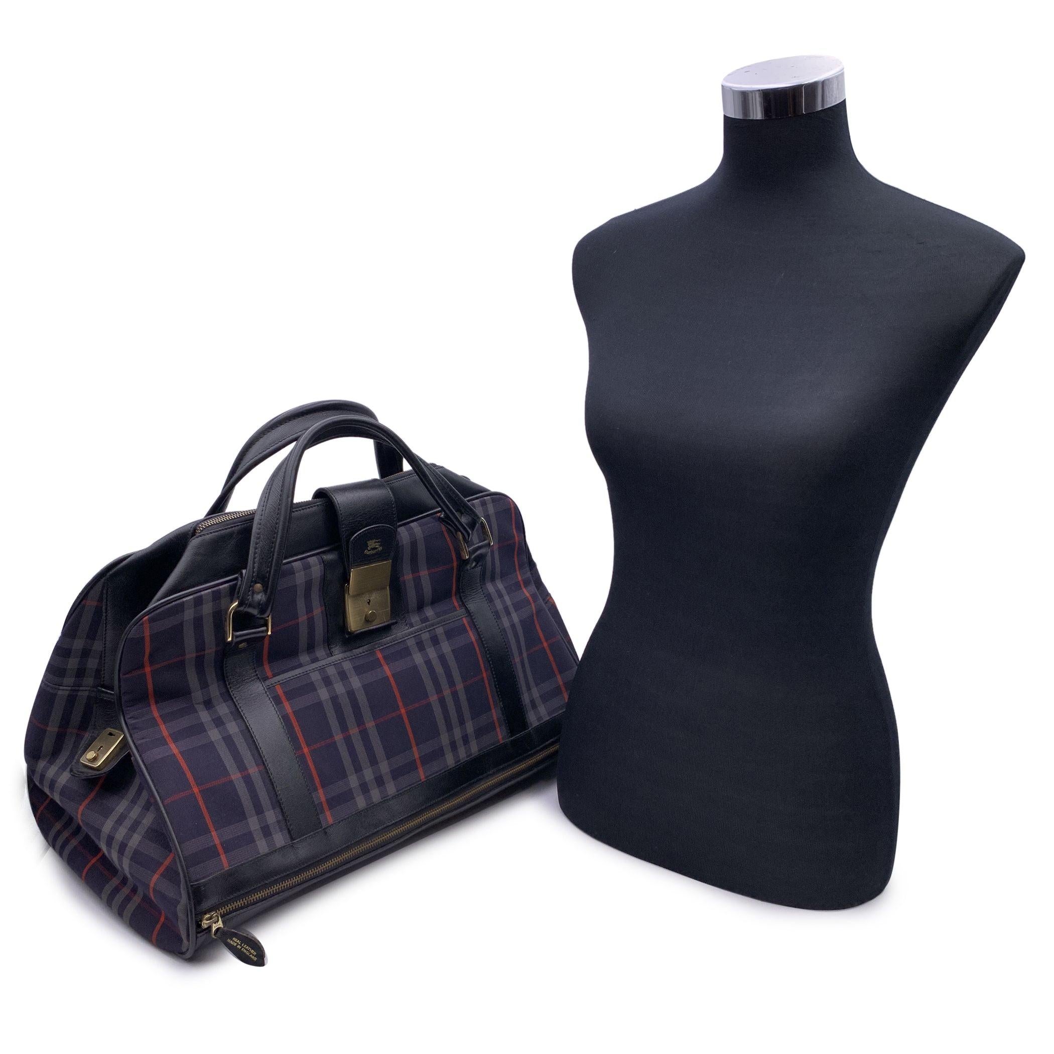 Unisex vintage weekender duffle bag by Burberry. Crafted of vintage blue Haymarket check canvas. The bag features blue leather strap top handles, a leather base with a front zipper pocket and a front open pocket and a rear zipper pocket . Fold over