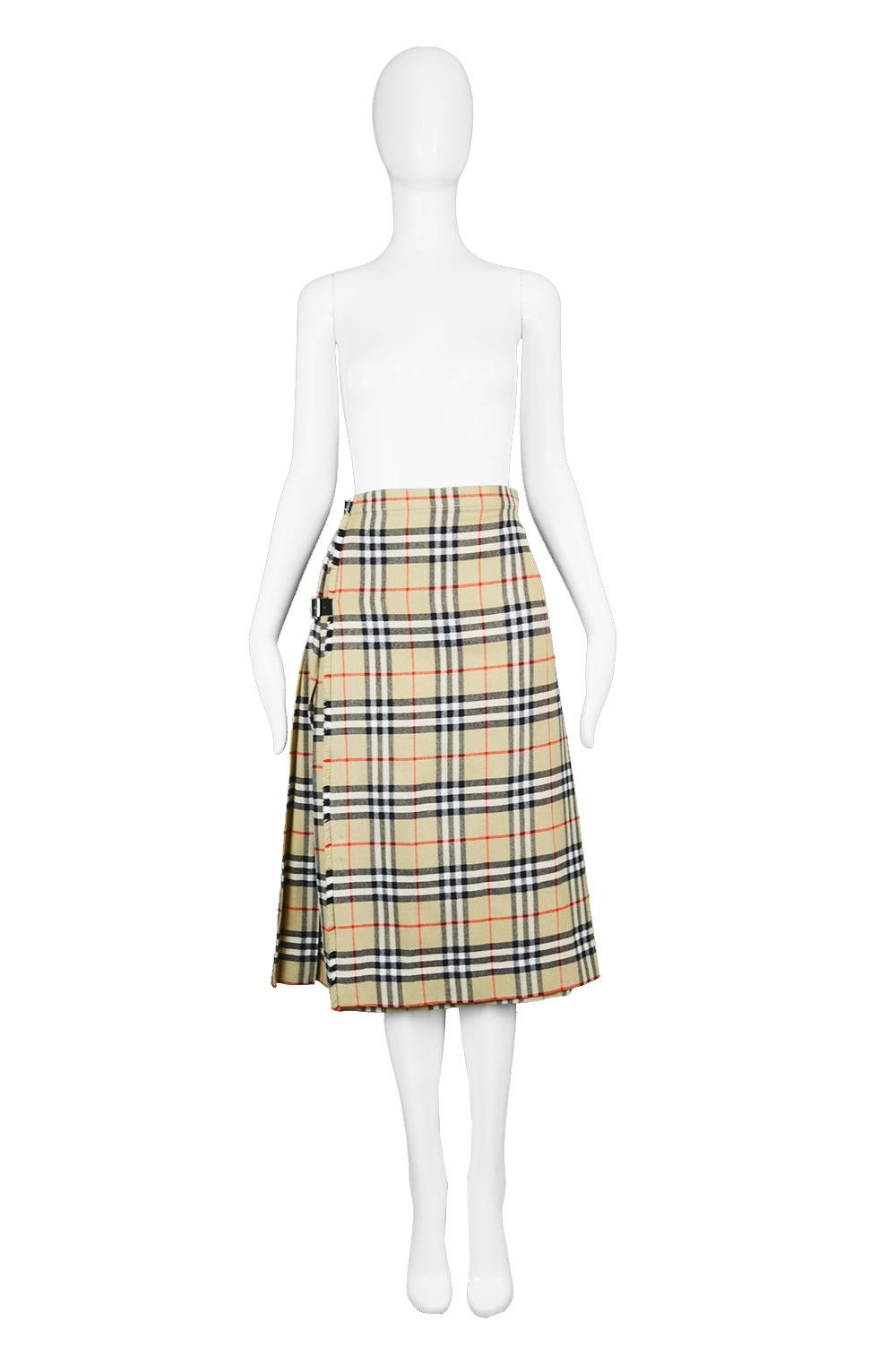 A fabulous vintage women's pleated skirt from the 80s by British luxury fashion house, Burberry (from before 1998 when they dropped the 's', they were known as Burberry's). In a beige pure wool with the iconic house check, 'Nova' checked throughout.