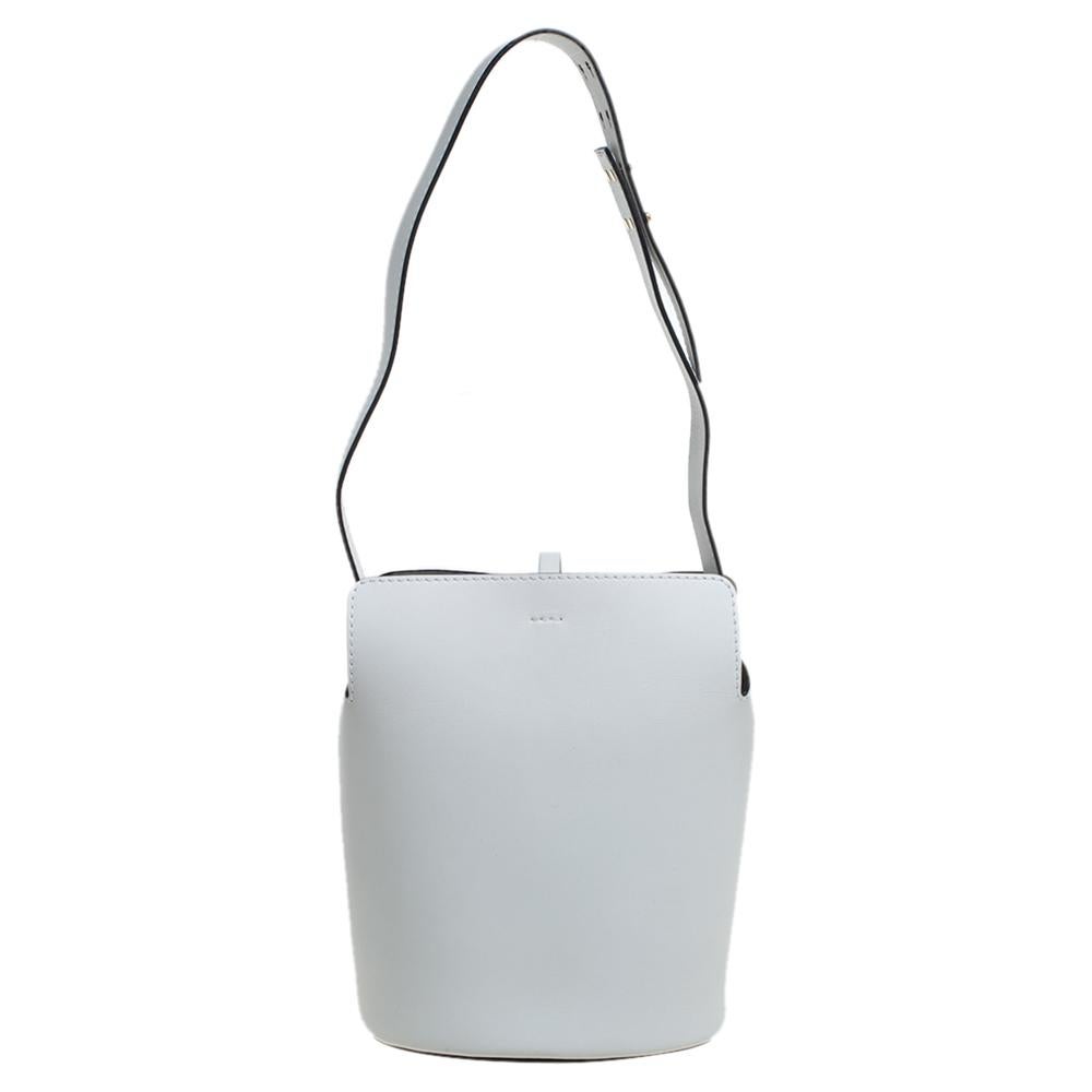 This practical and trendy bucket bag by Burberry is a must-have in every fashionista's closet! It is crafted from pristine white leather and features a well-sized interior for your essentials. Adjust the broad strap for a perfect drop and swing it