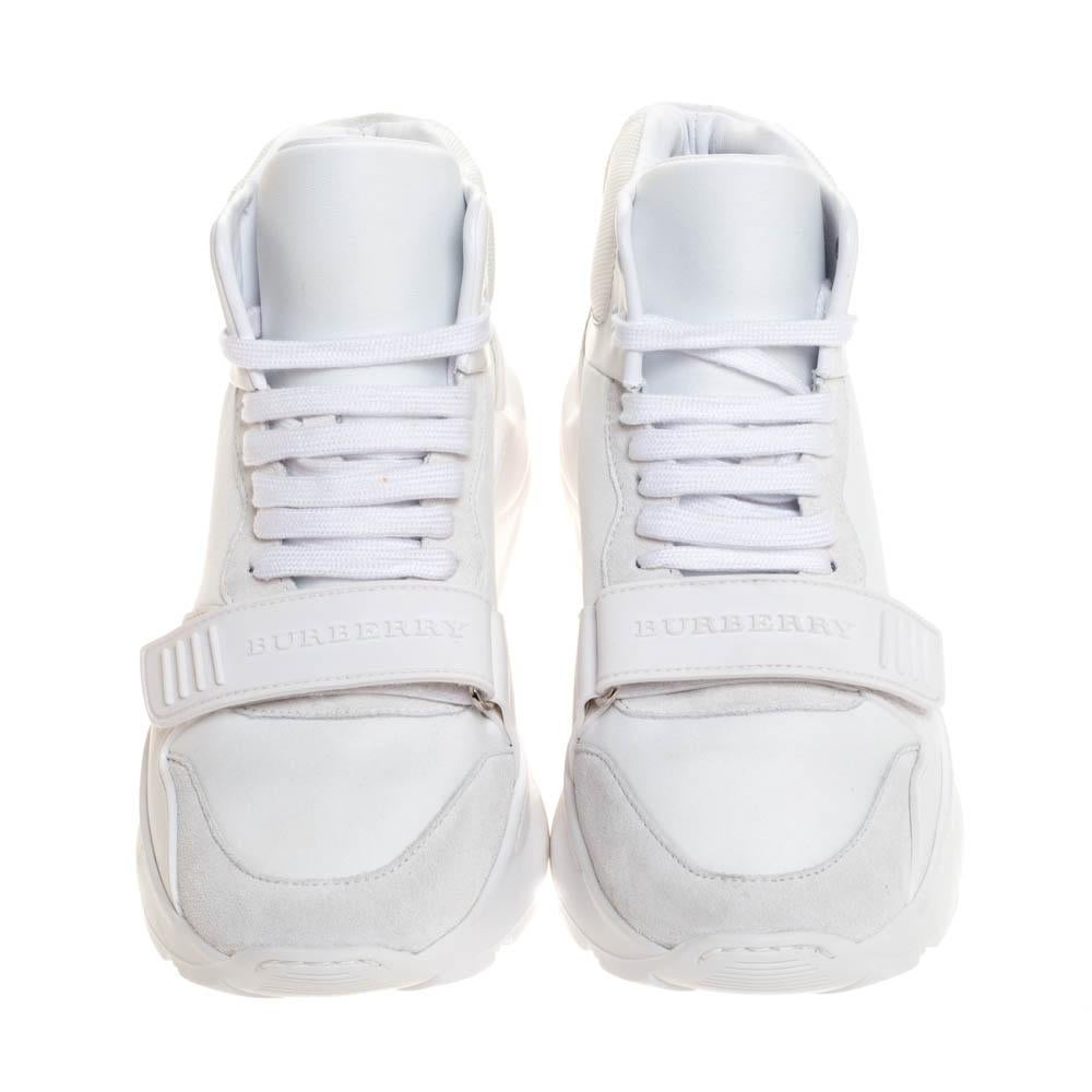 These sneakers from the House of Burberry are fashioned from a combination of suede, nylon and leather into a stylish high-top silhouette. The Regis L pair comes with lace-up vamps, velcro straps with the brand detail, brand detail at the heels,