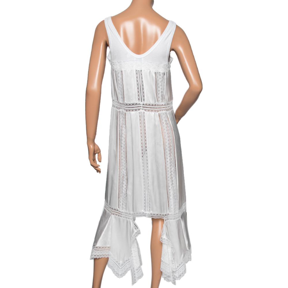 Bring feminine grace and demure to your closet with this beautiful slip dress from the House of Burberry. It is stitched using white satin silk and intricate Chantilly lace. It is accentuated with a steep neckline, a sleeveless style, and an