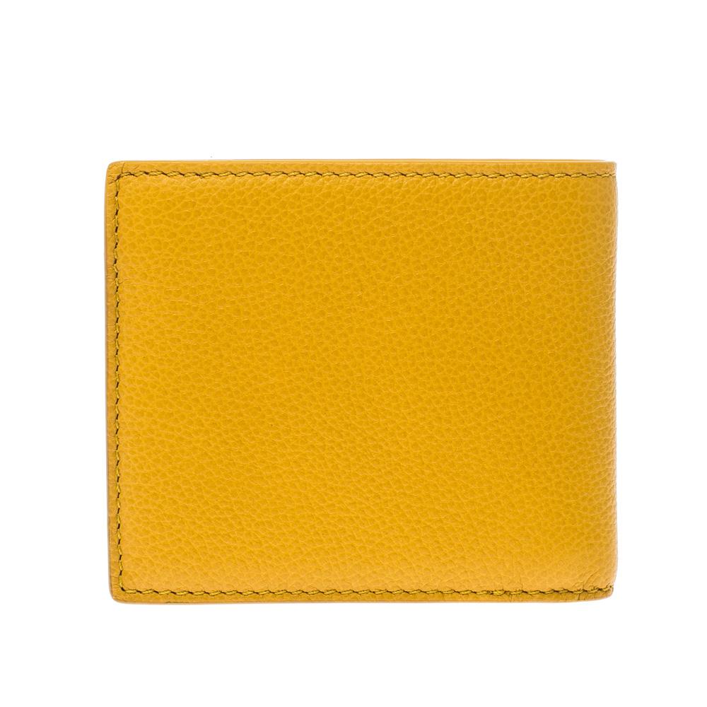 Wallets are a must-have, everyday accessory! Crafted from bright yellow leather, this Burberry wallet has been styled as a bifold. The insides are fabric-lined and equipped with multiple card slots and enough space to place your cash and