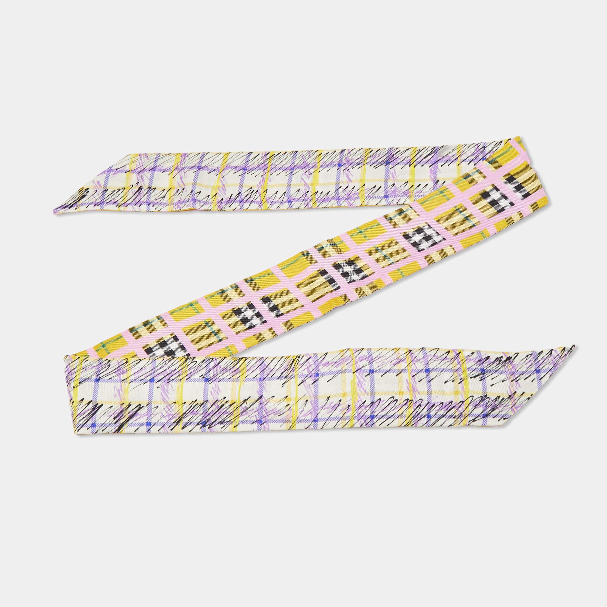 The Burberry twilly is a luxurious fashion accessory made from high-quality silk. It features a vibrant and intricate print, creating a visually stunning and eye-catching design. This twilly is versatile, serving as a scarf, headband, or belt,