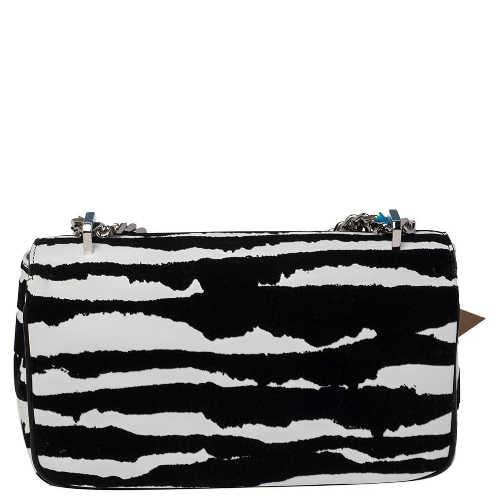 Carry this Burberry Lola bag with confidence. Crafted in Italy, it is made from zebra-printed velvet and leather. The front flap features the brand logo and opens to reveal a fabric-lined interior with enough space for essentials. The bag is