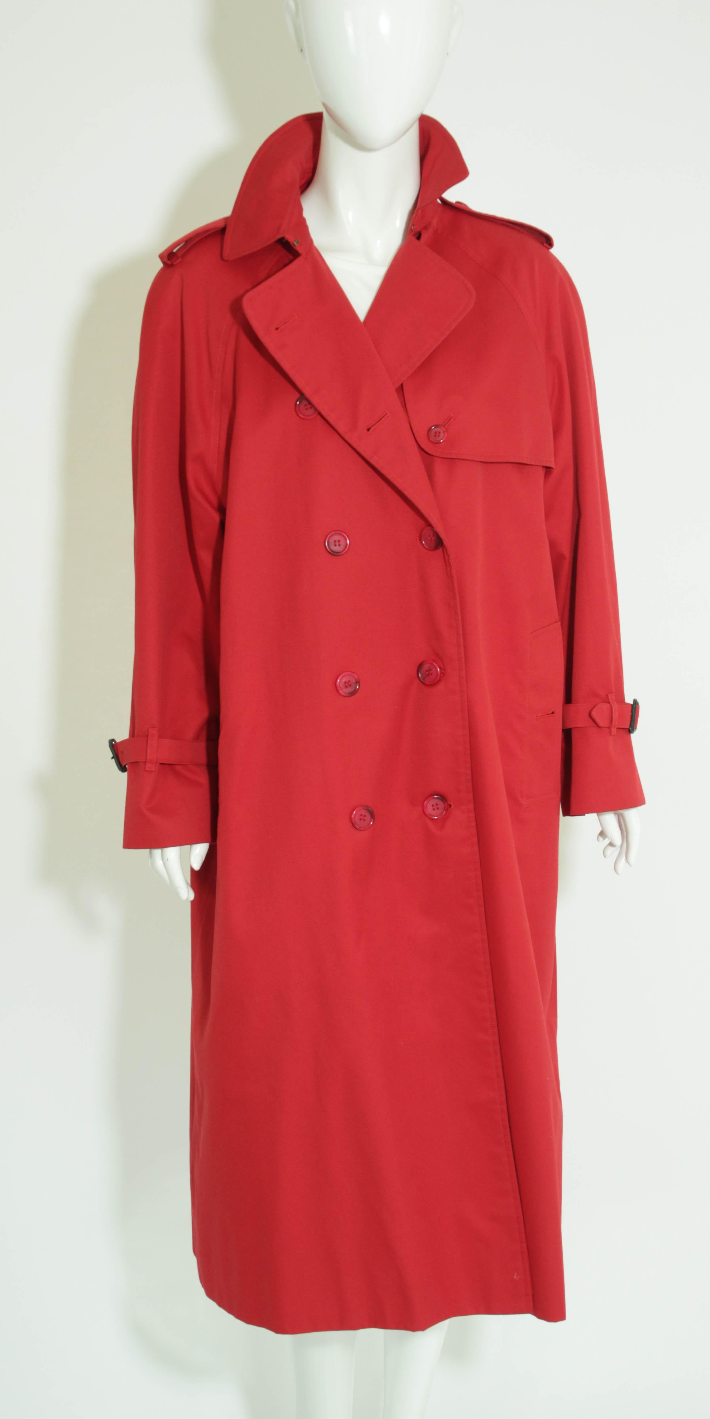 BURBERRY'S Cherry Red Nova Plaid Trench Cotton Double Breasted.
Burberry's trench coat,  classic cherry red gabardine trench dating to the 1980's. 
An excellent vintage trench coat Mackintosh by Burberry from circa 1980s when, prior to dropping the