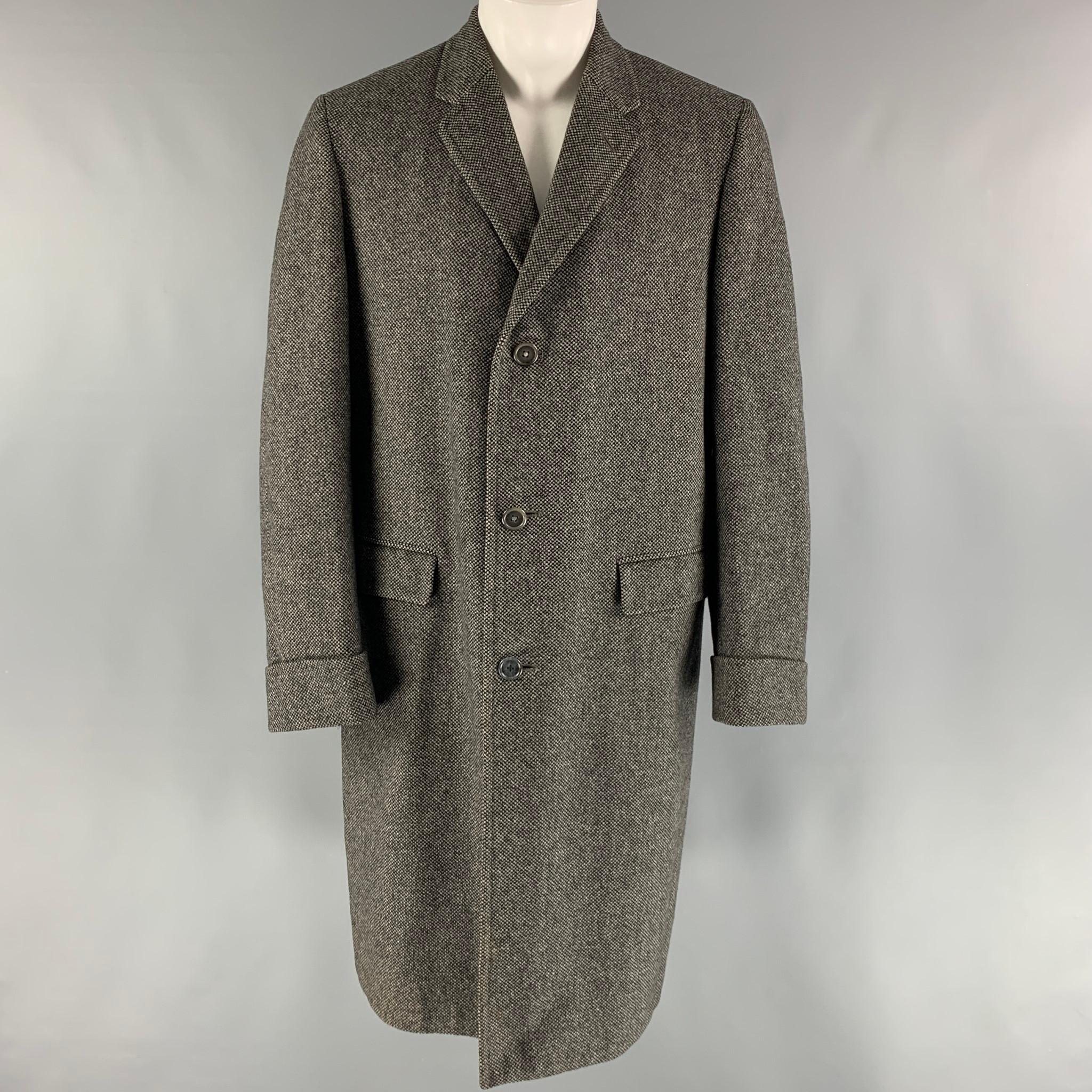 BURBERRYS VINTAGE Long Coat comes in a black and grey nailhead wool woven material, with a notch lapel, flap pockets, three buttons at closure, single breasted, and a single vent at back. Made in England.

Excellent Pre-Owned Condition.
Marked: no
