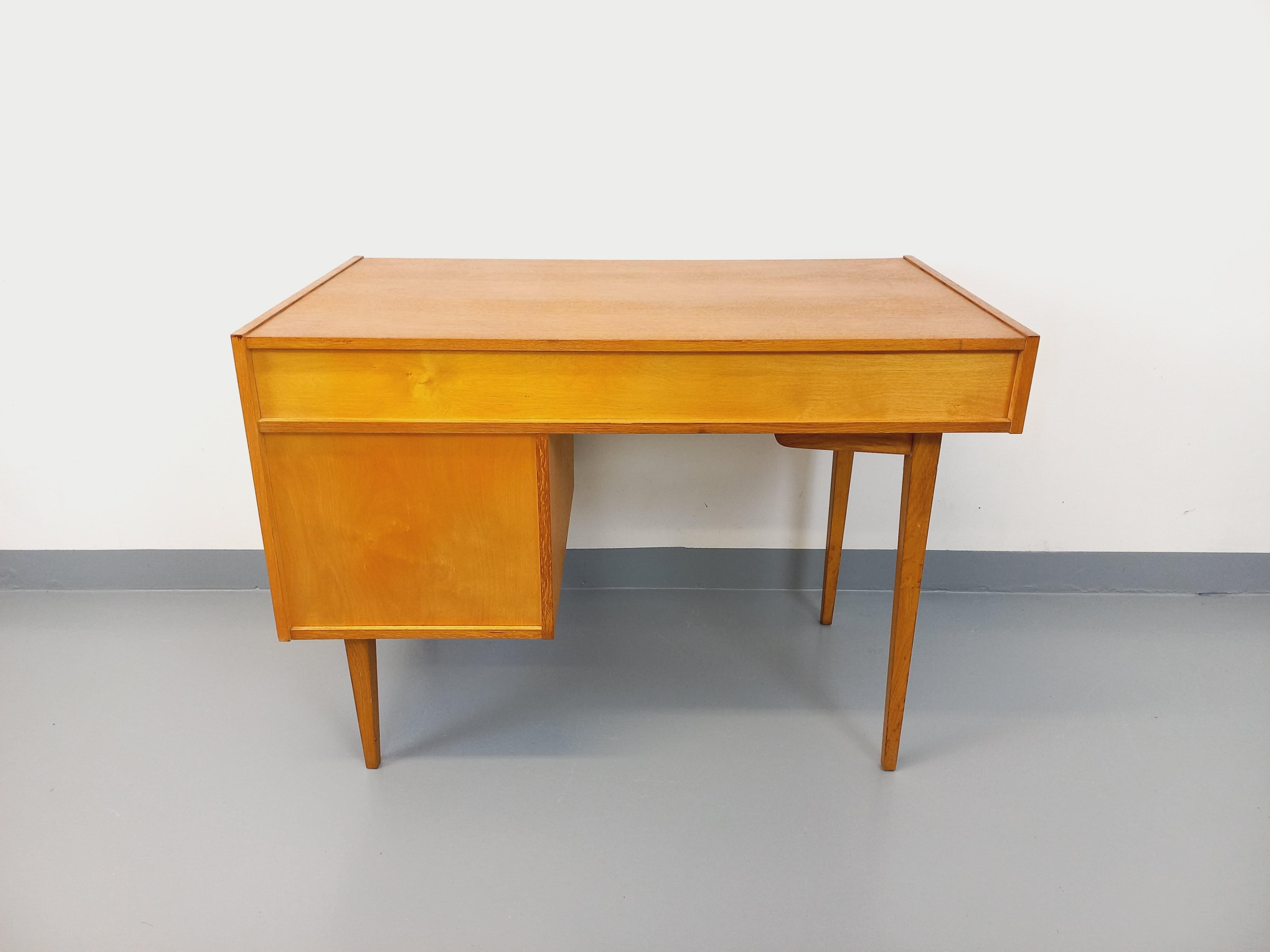 Bureau vintage des années 60, en bois de chêne, 1 tiroir, 1 niche ouverte, 1 porte avec clé noire et étagère intérieure, pieds compas. Très bon état général, plateau poncé et verni. Se puede utilizar en el centro de un mueble (el dosificador es muy