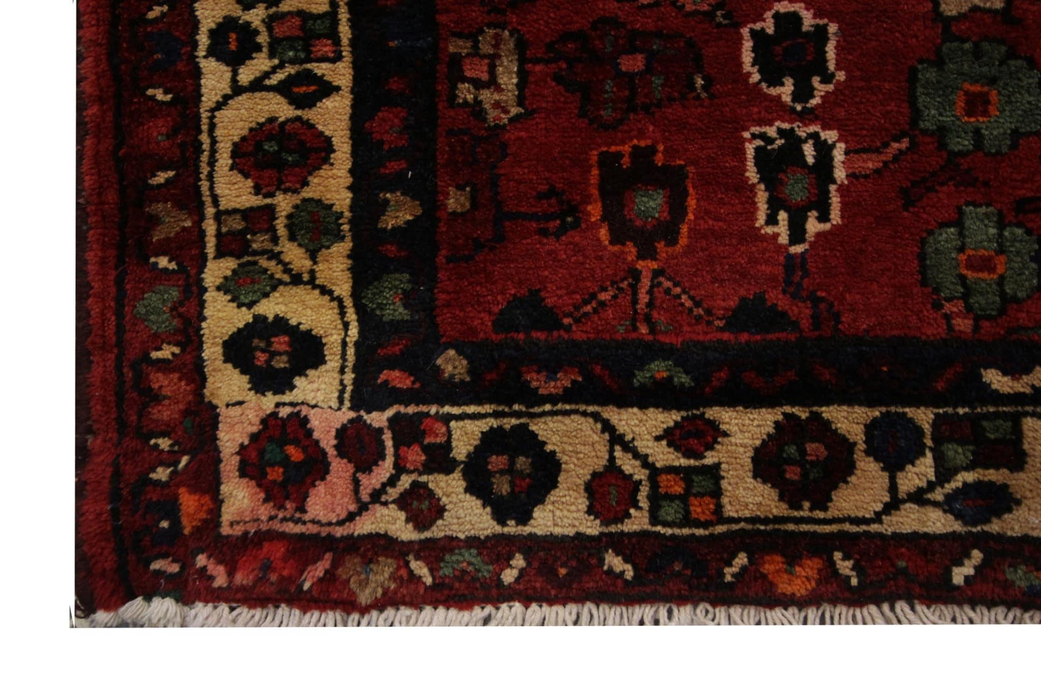 This burgundy runner rug is a magnificent blend of vintage elegance and floral charm. Hand-knotted with precision and crafted to perfection, this exquisite piece carries the legacy of the 1950s, radiating an aura of authenticity and history.
