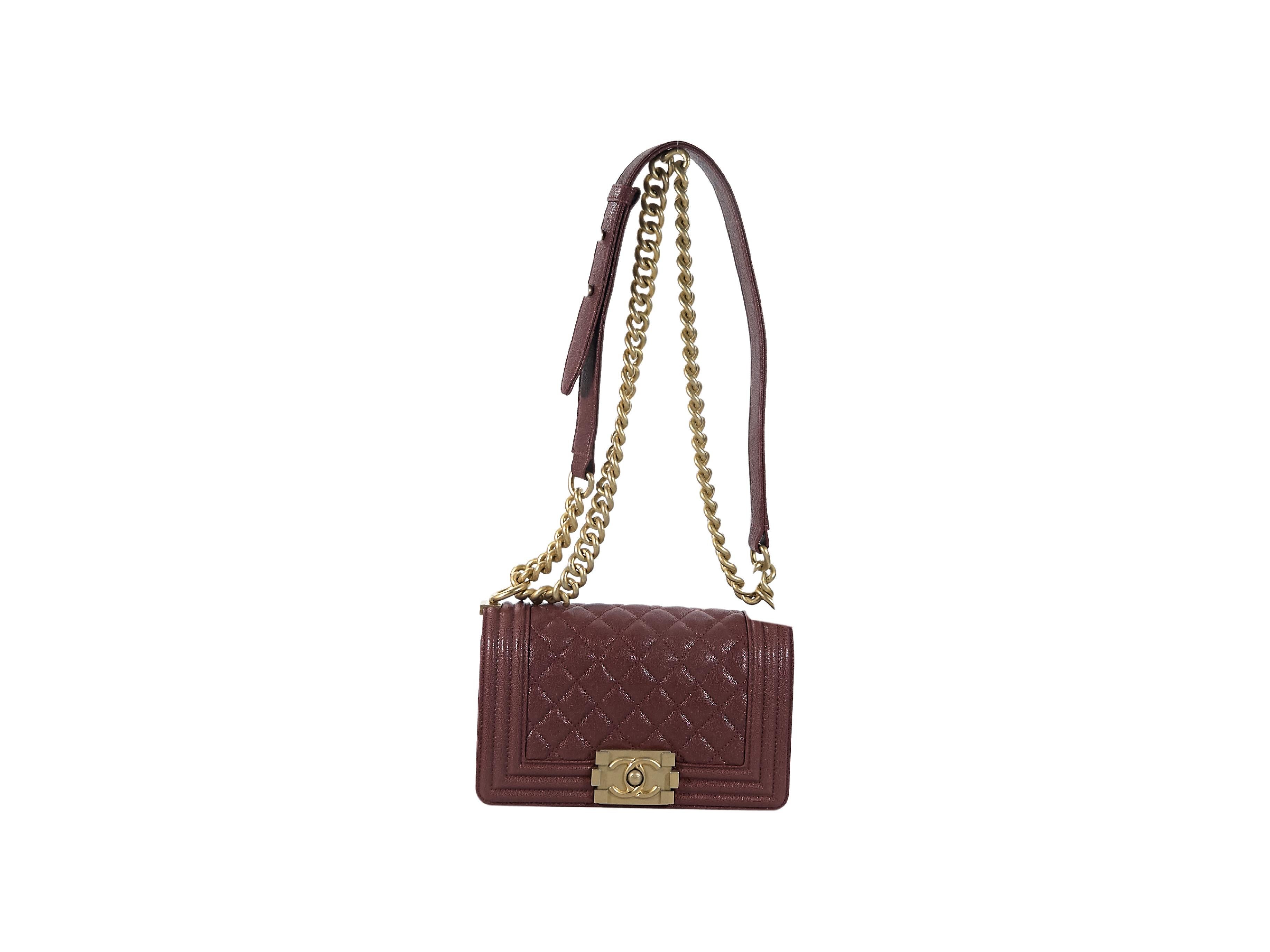 Product details:  Burgundy quilted caviar leather Boy bag by Chanel.  From 2018.  Adjustable leather and chain crossbody strap.  Front flap with push-lock closure.  Lined interior with inner slide pocket.  Goldtone hardware.  Authenticity card