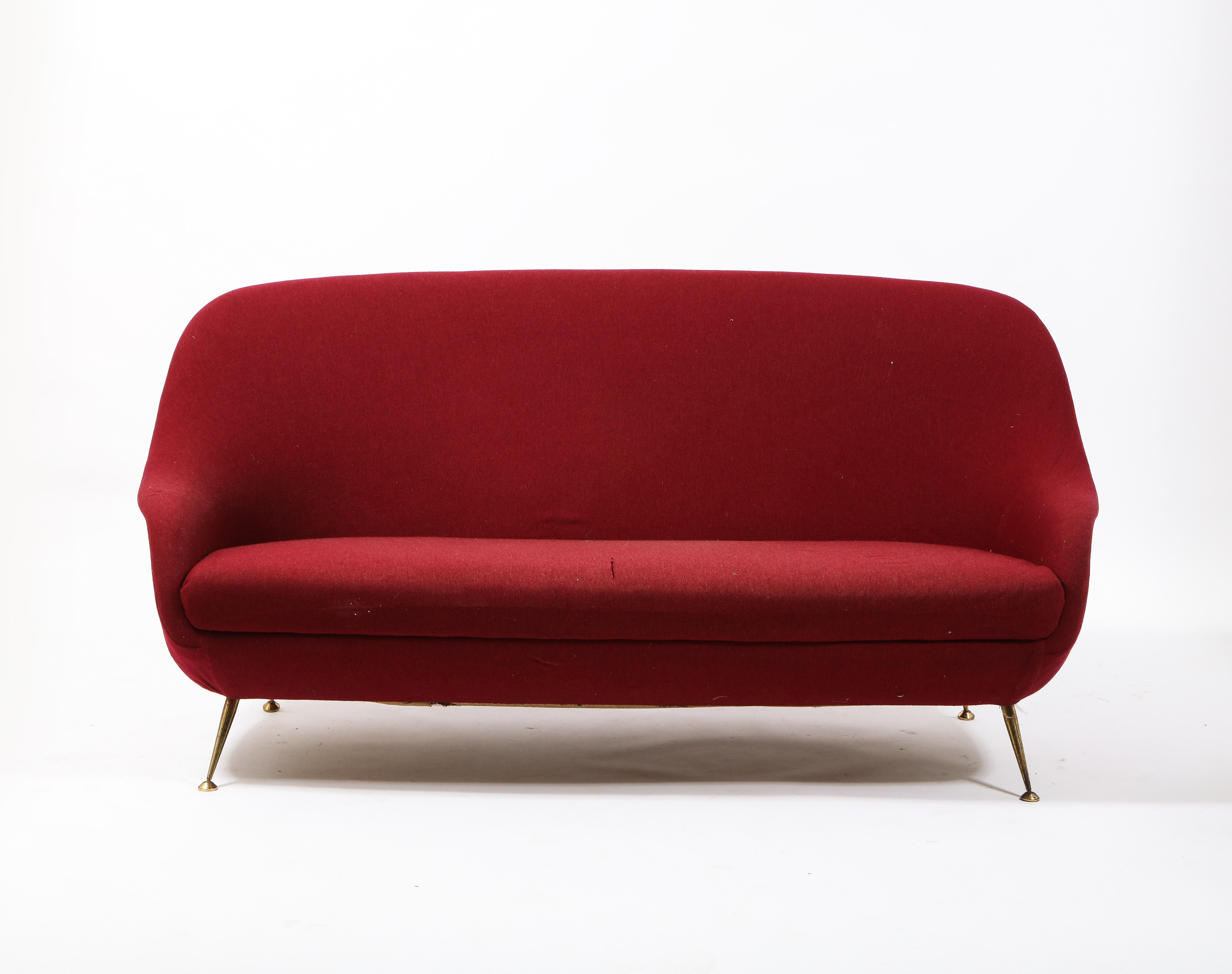 Elegant burgundy sofa on brass legs. Sofa will need full upholstery.