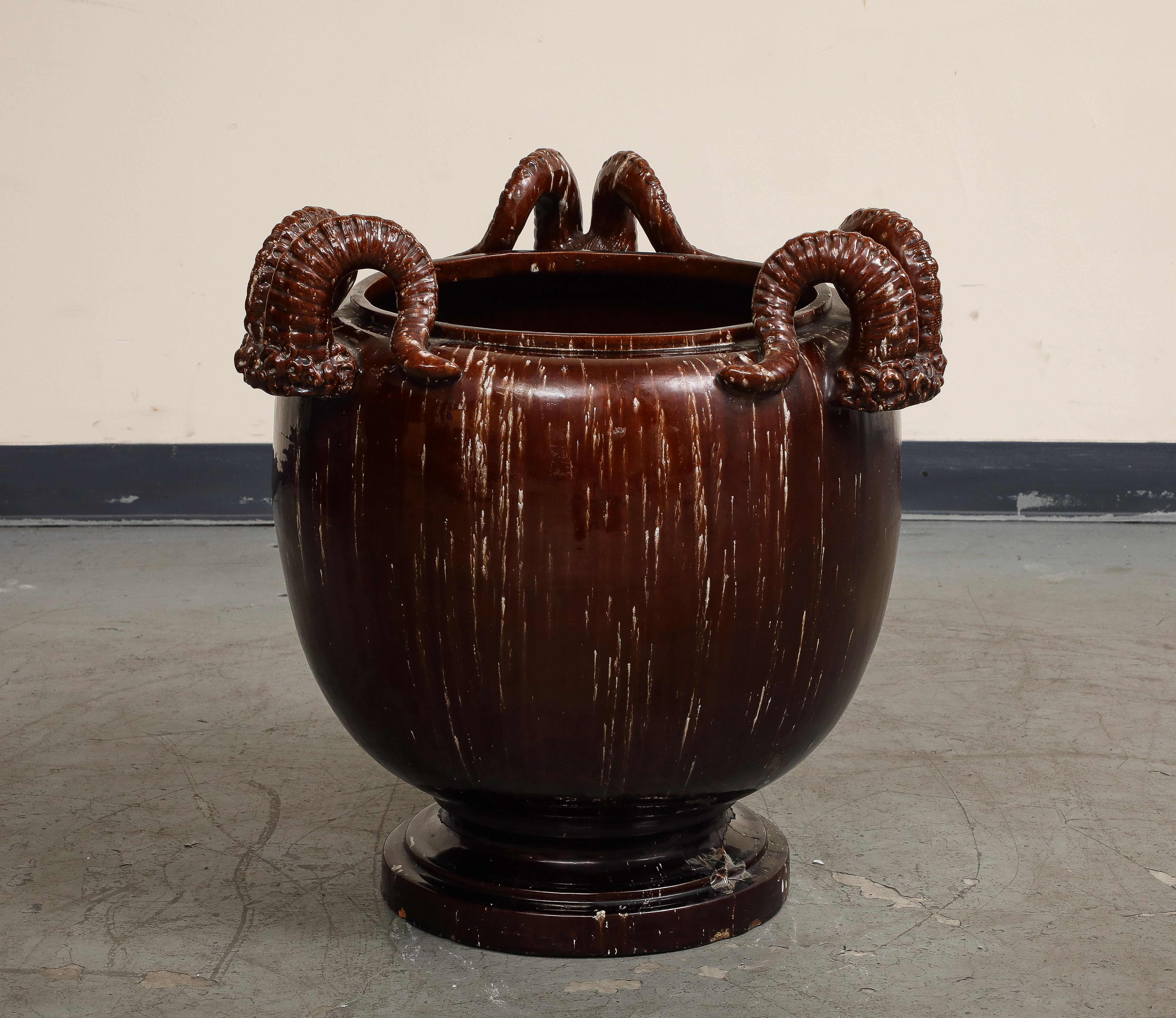 Burgundy Glazed Chinese Pottery Jardiniere with Ram's Horns, 20th Century. 

opening 14 3/4