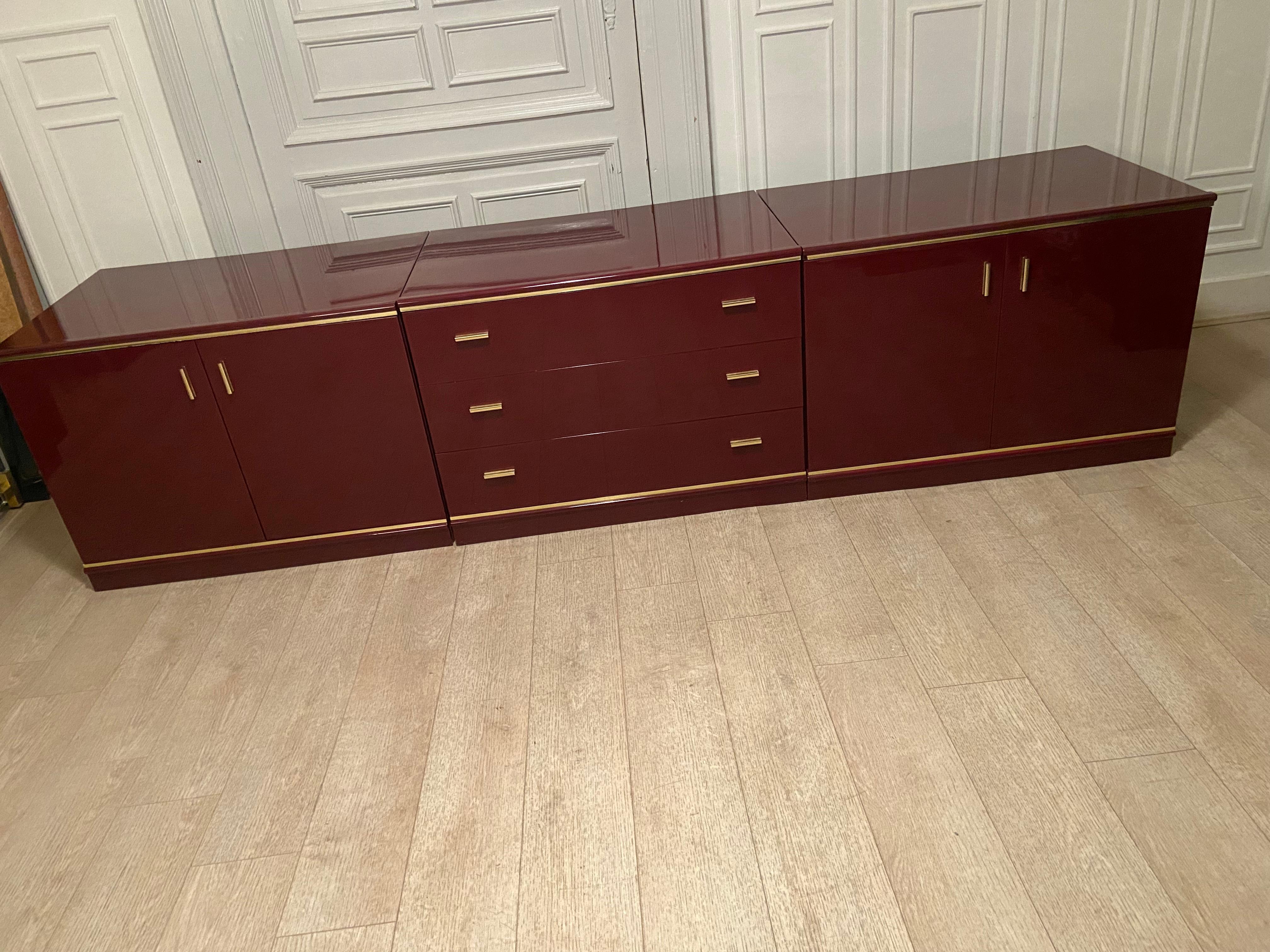 Burgundy lacquered and brass sideboard, 1970s.