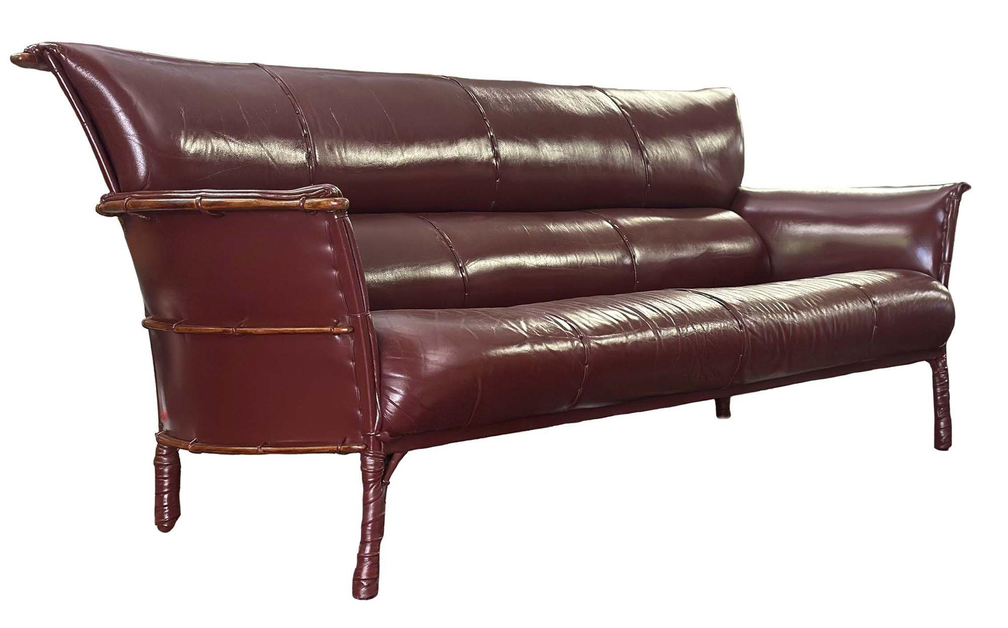 Versatile and stylish burgundy leather sofa by Pacific Green. The leather has been newly reconditioned and the back of the frame is wrapped around palm wood ribs.
From Pacific Green Website:
