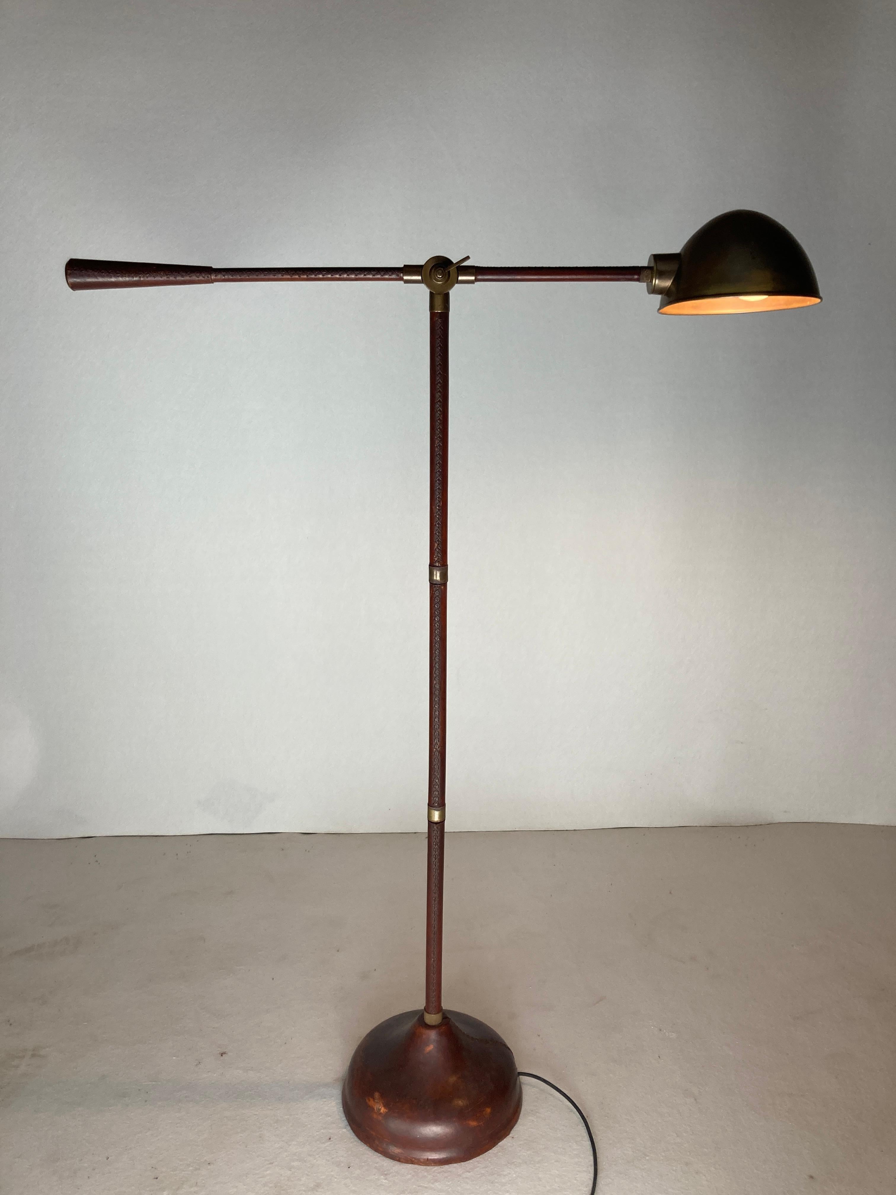 Remarkable leather wrapped and stitched floor lamp which is often named in the style of Jacques Adnet who amongst others was famous for his work with leather and also very reminiscent of the leather lamps made by Valenti. Although it came to us as