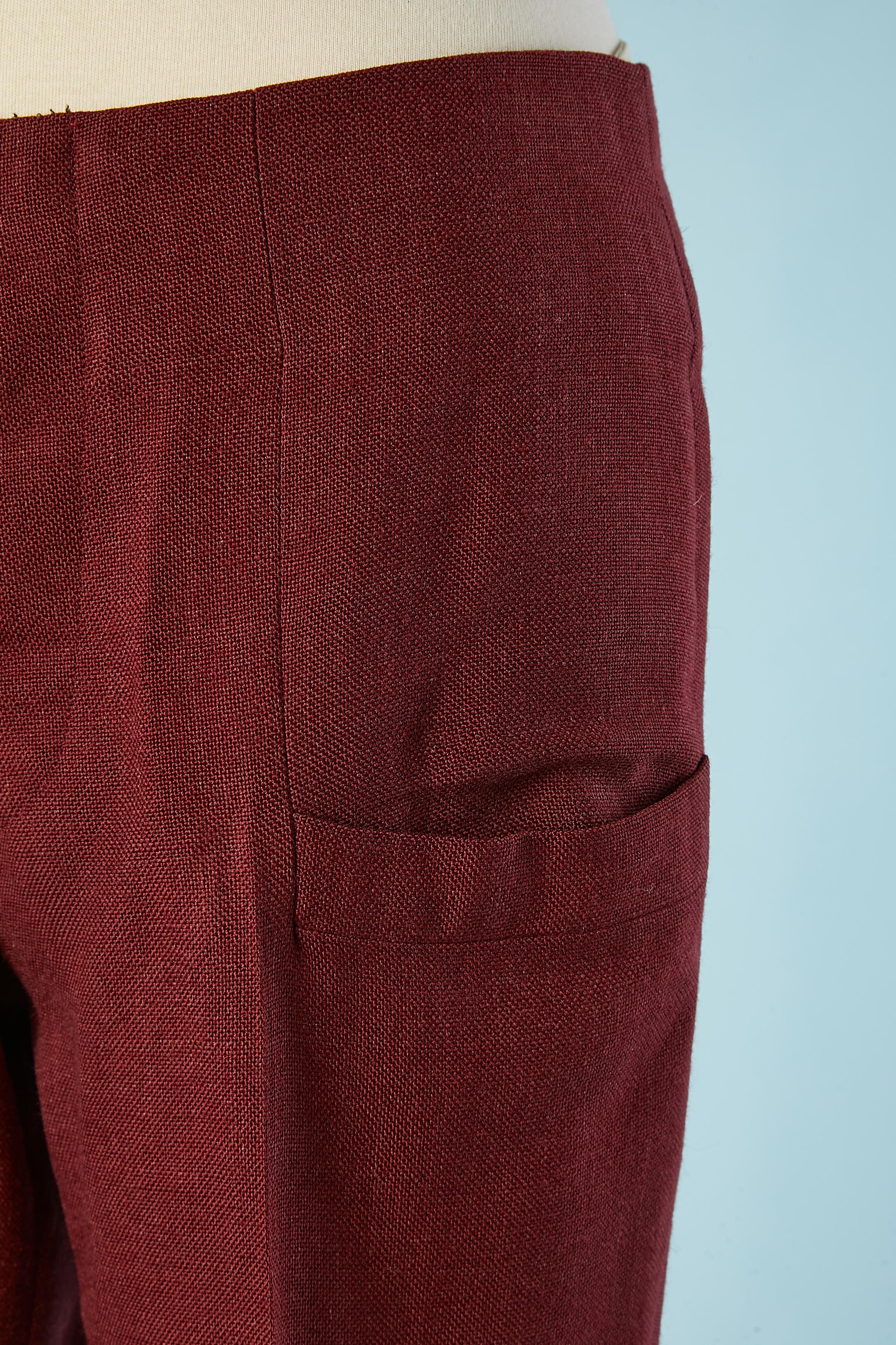 Burgundy linen and acrylic high-waisted trouser. Button placket inside the waist. 
Buttons and buttonholes closure in the top middle front. Nylon lining inside the pocket and nylon waist. 
SIZE L 