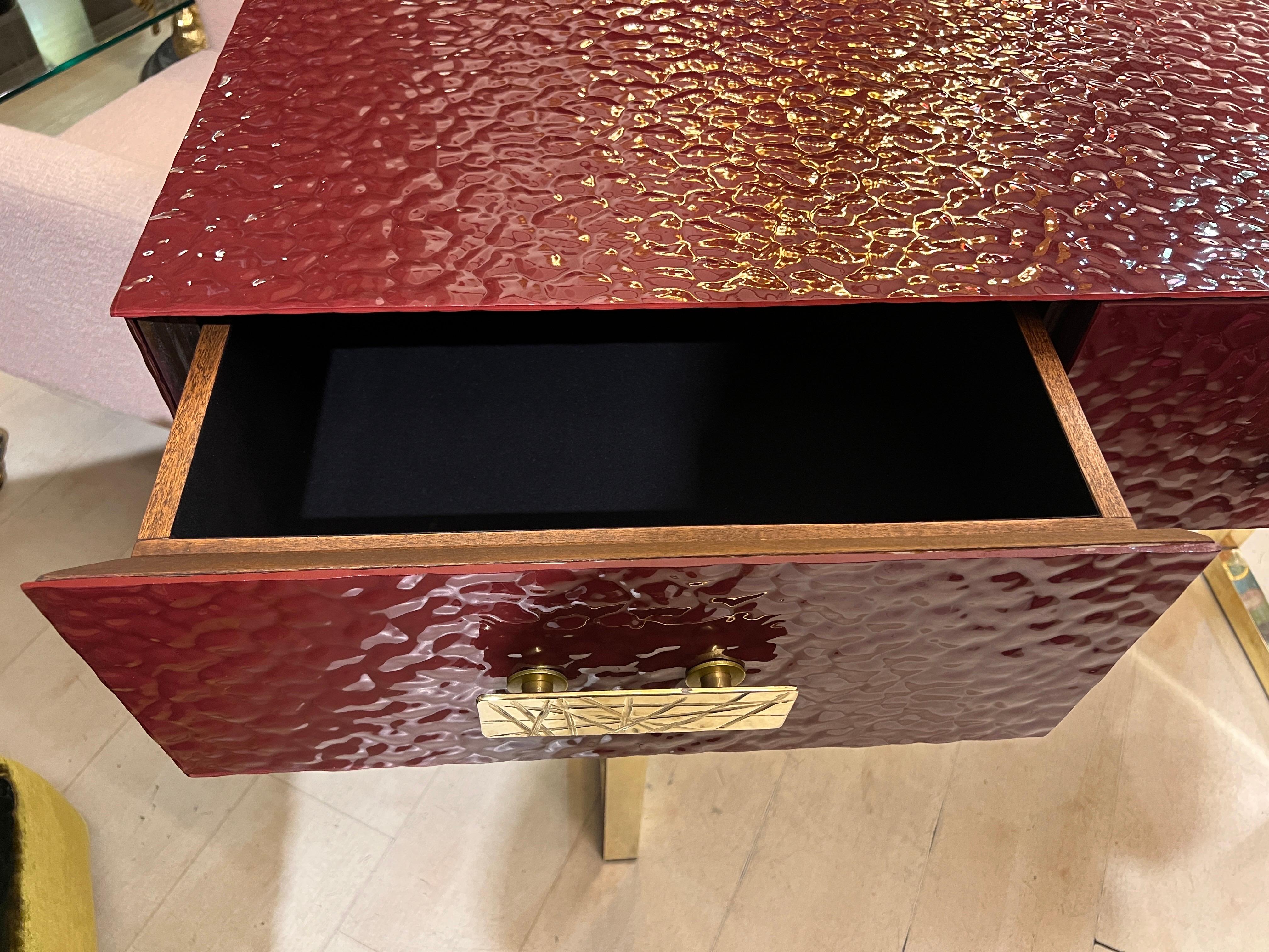 Burgundy Murano Ashlar Glass and Brass Console Table with Three Drawers. Brass legs and handles with scratched effect. The inside of the drawers is covered in black velvet.