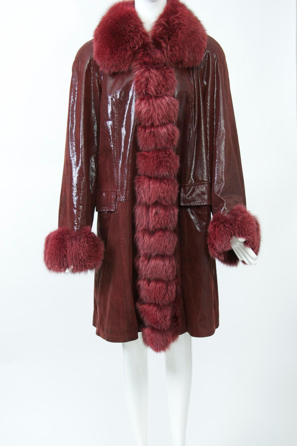 Luscious color in a swing-style coat featuring a fox collar, cuffs and trim down both front sides. The fabric looks like solid patent leather, but is actually composed of tiny patent dots that lend a shimmery appearance. Further details include flap