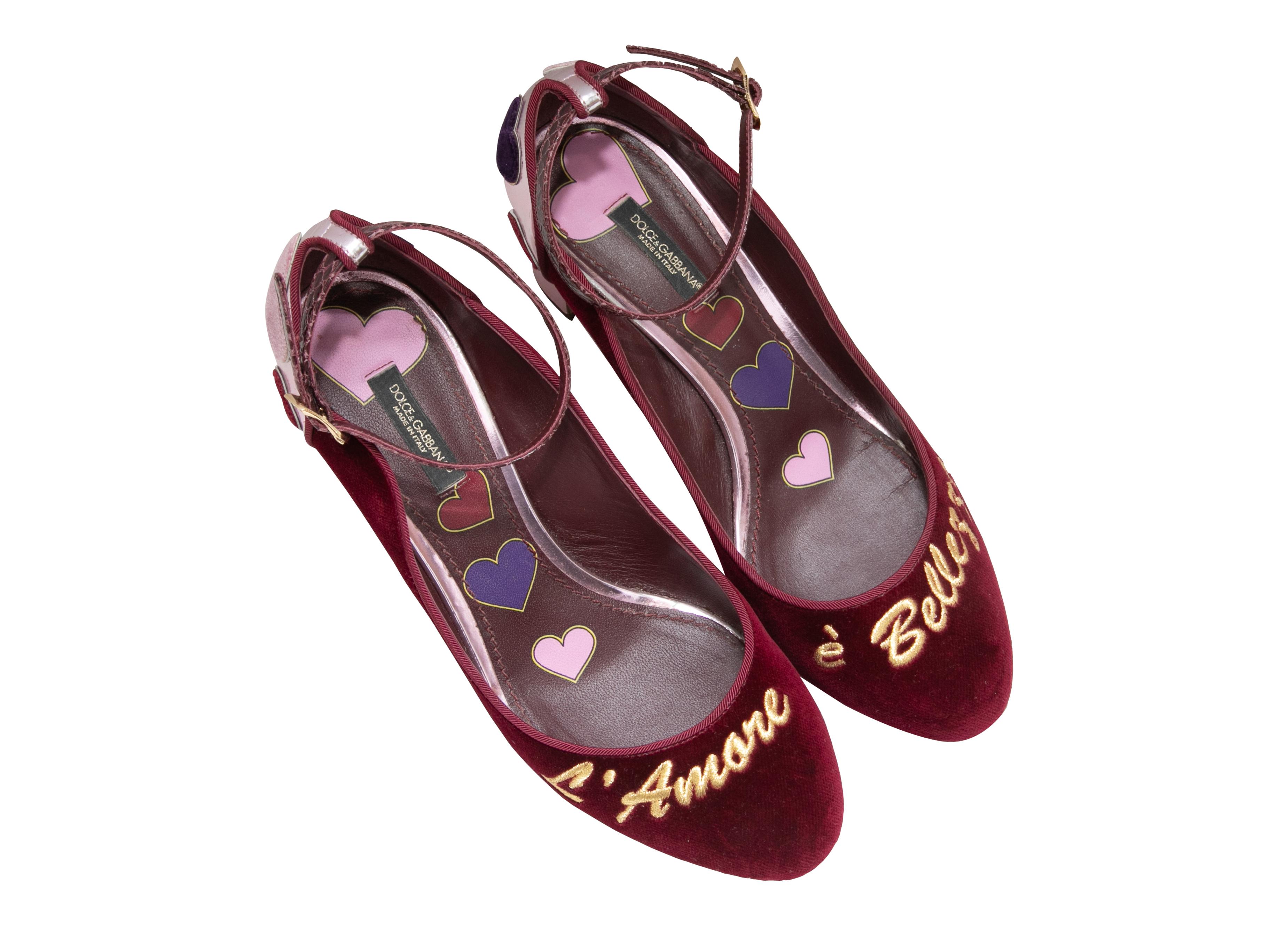  Burgundy velvet and pink metallic leather round-toe pumps by Dolce & Gabbana. Heart detailing at counters. Gold-tone embroidery at tops. Buckle closures at ankle straps. 2.75