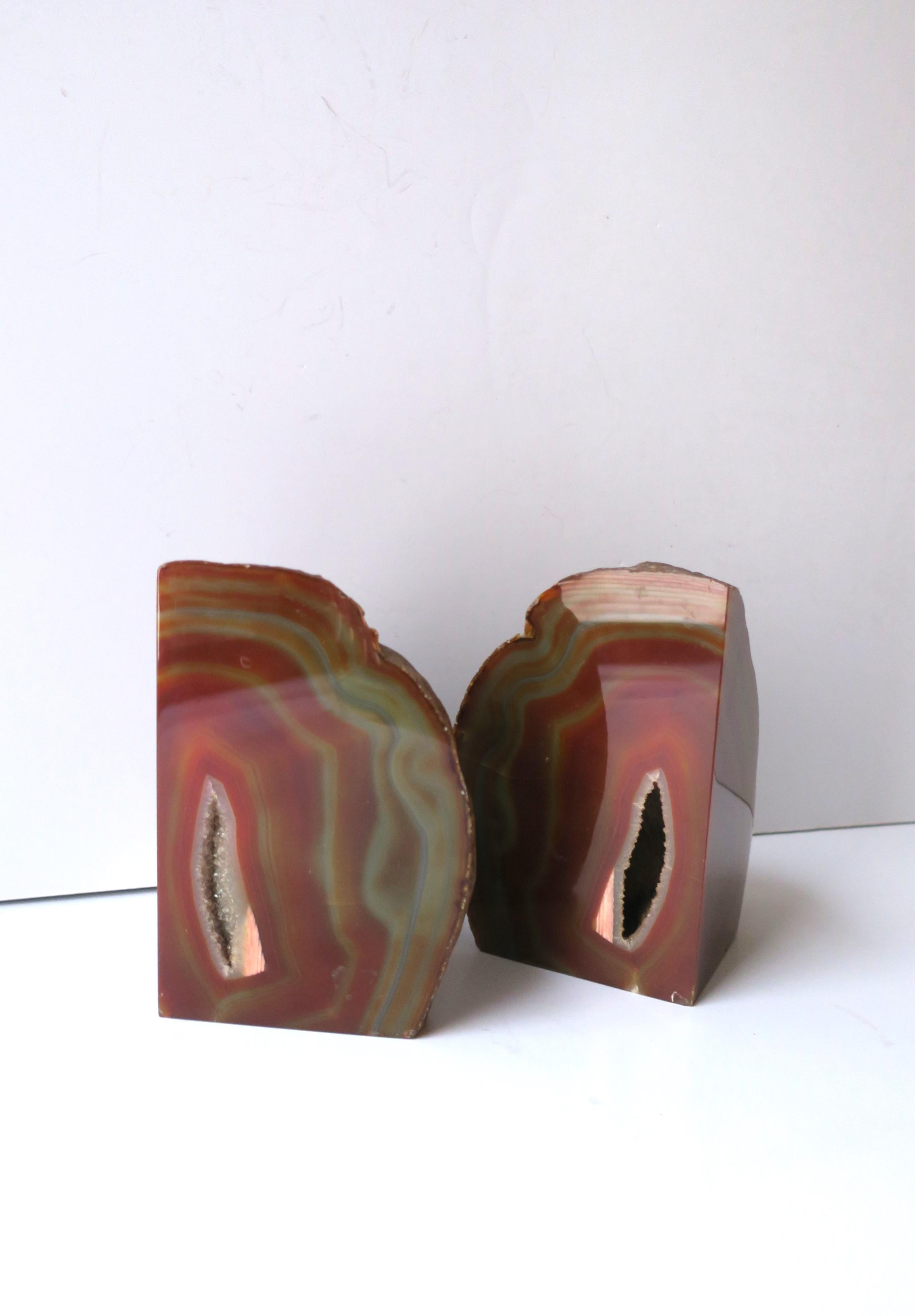 A substantial and beautiful pair of red burgundy agate onyx bookends or decorative objects, in the modern or Organic Modern style, circa late-20th century. Demonstrated supporting coffee table books. Very good condition as shown in images. Pair are