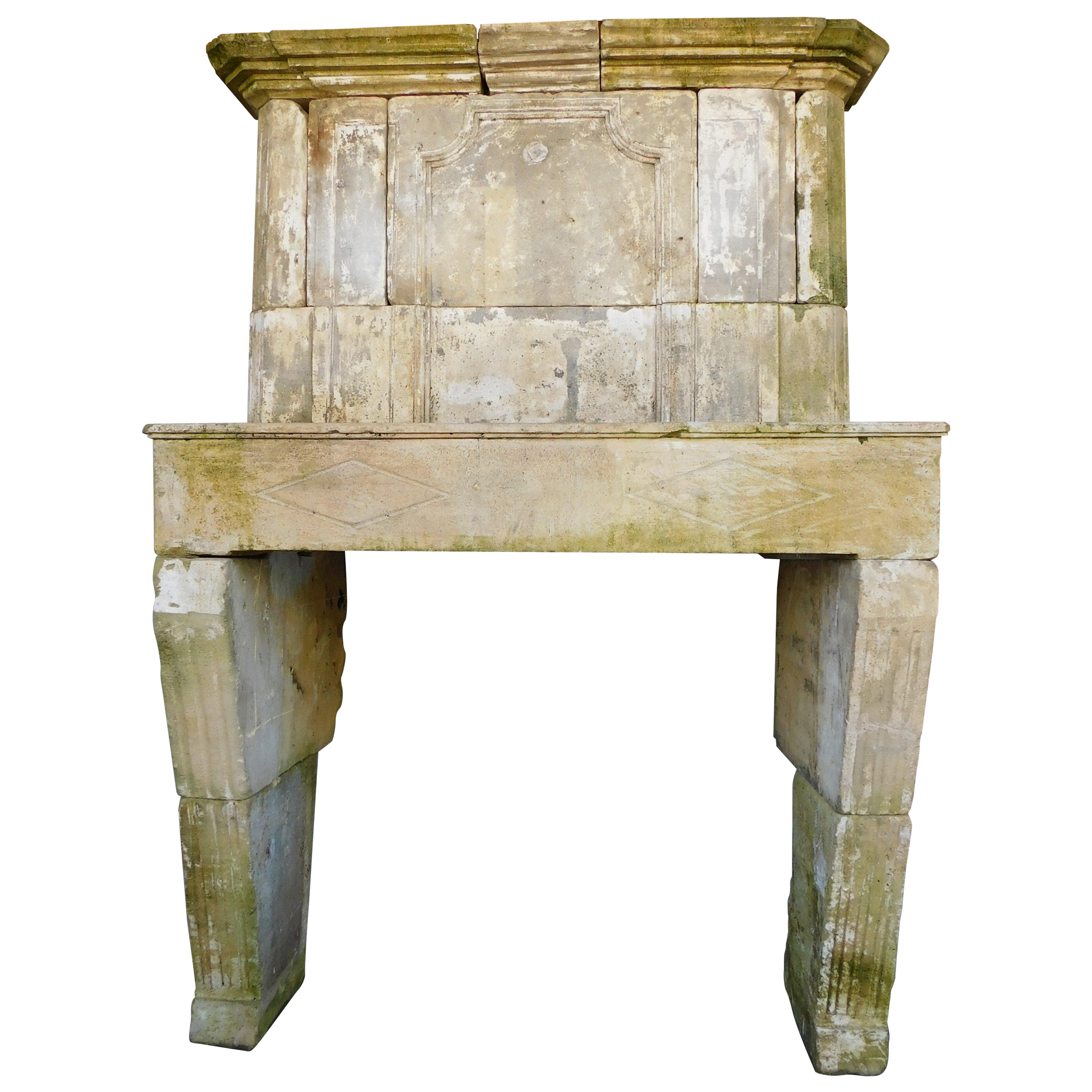 Burgundy stone fireplace carved with trumeau above hood, France