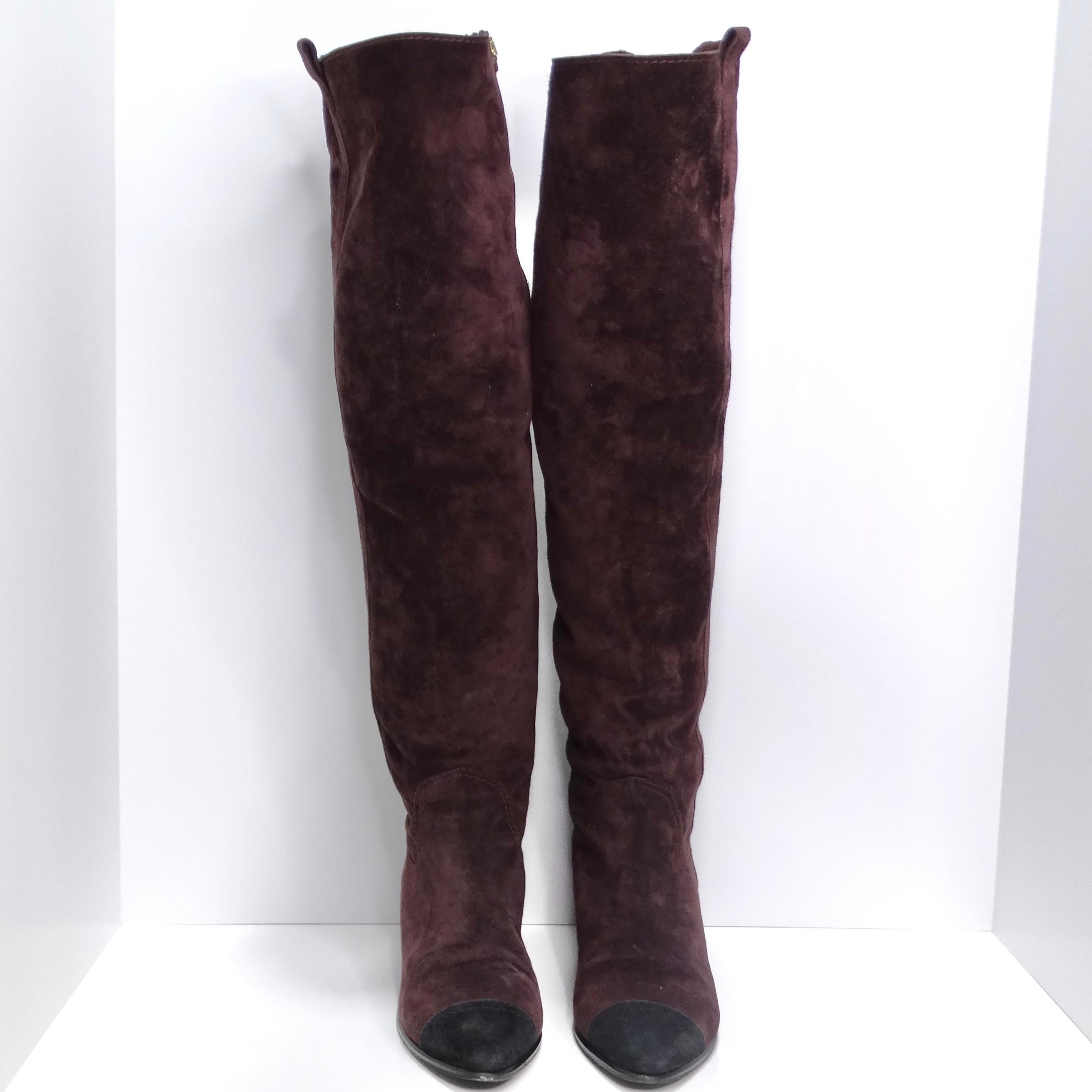 Step into sophistication with the Chanel Russian Burgundy Suede Cap Toe Over-The-Knee Boots – a luxurious and elegant statement piece. These boots feature sumptuous burgundy suede complemented by black suede cap toes, creating a harmonious blend of
