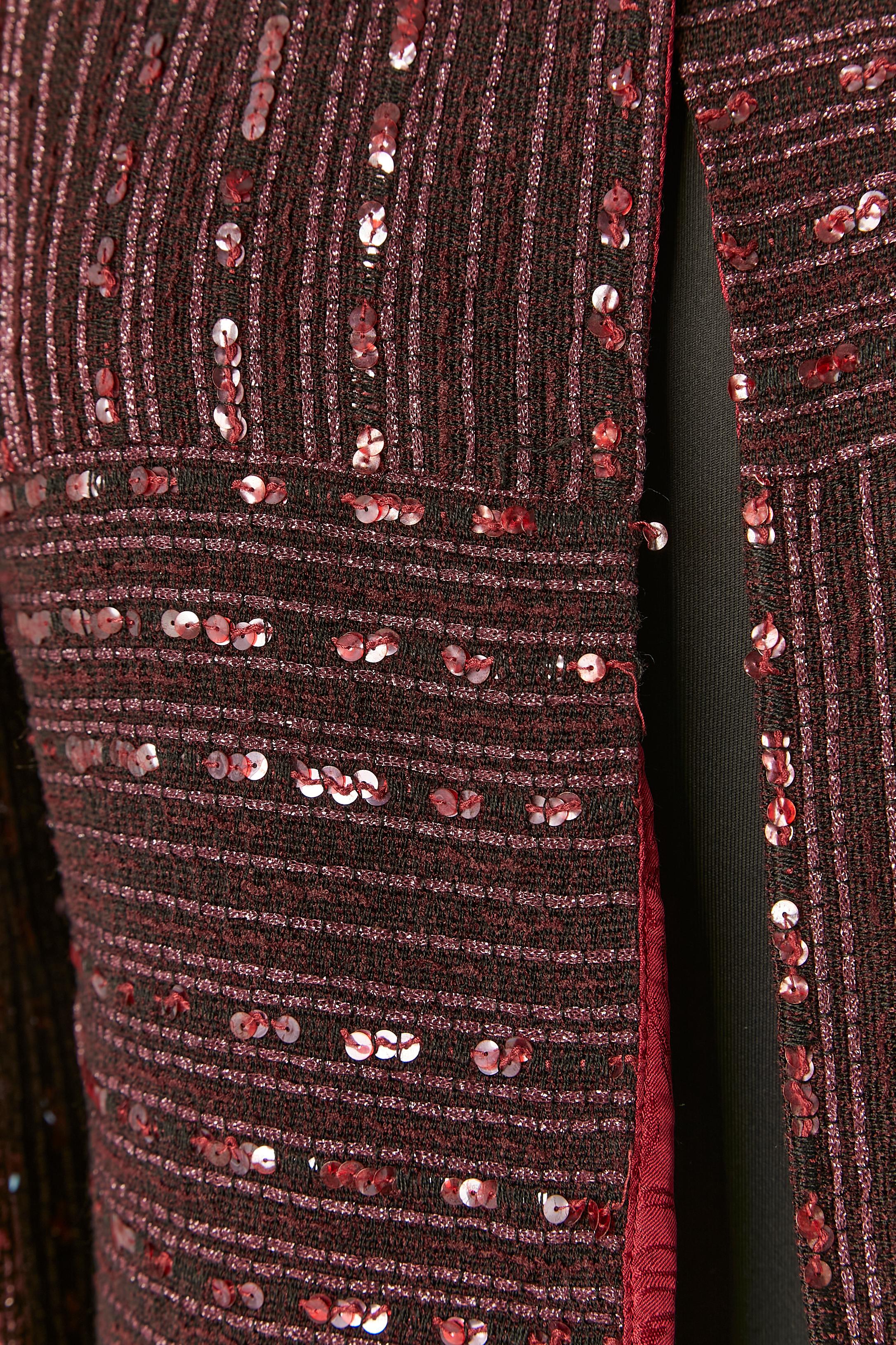 Giacca monopetto in tweed bordeaux con paillettes. Fodera in seta jacquard con marchio. 
Catena all'interno della giacca sul bordo inferiore. Un bottone rosa con marchio e chiusura ad asola sulla parte centrale del davanti. 
TAGLIA 38 (Fr) M 