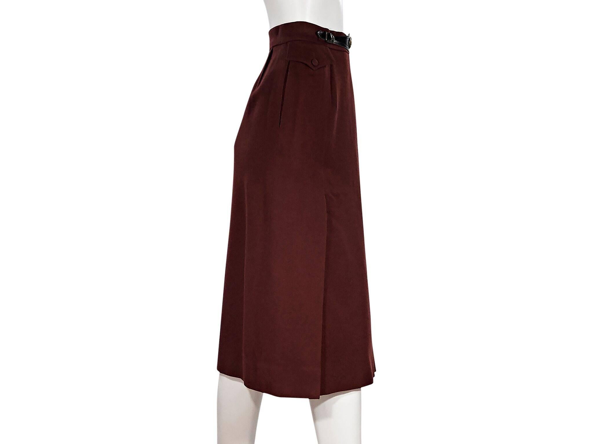 Product details:  Vintage burgundy wool skirt by Hermes.  Belt accent at waist.  Concealed side zip closure.  Side button flap pocket.  Label size FR 36.  26