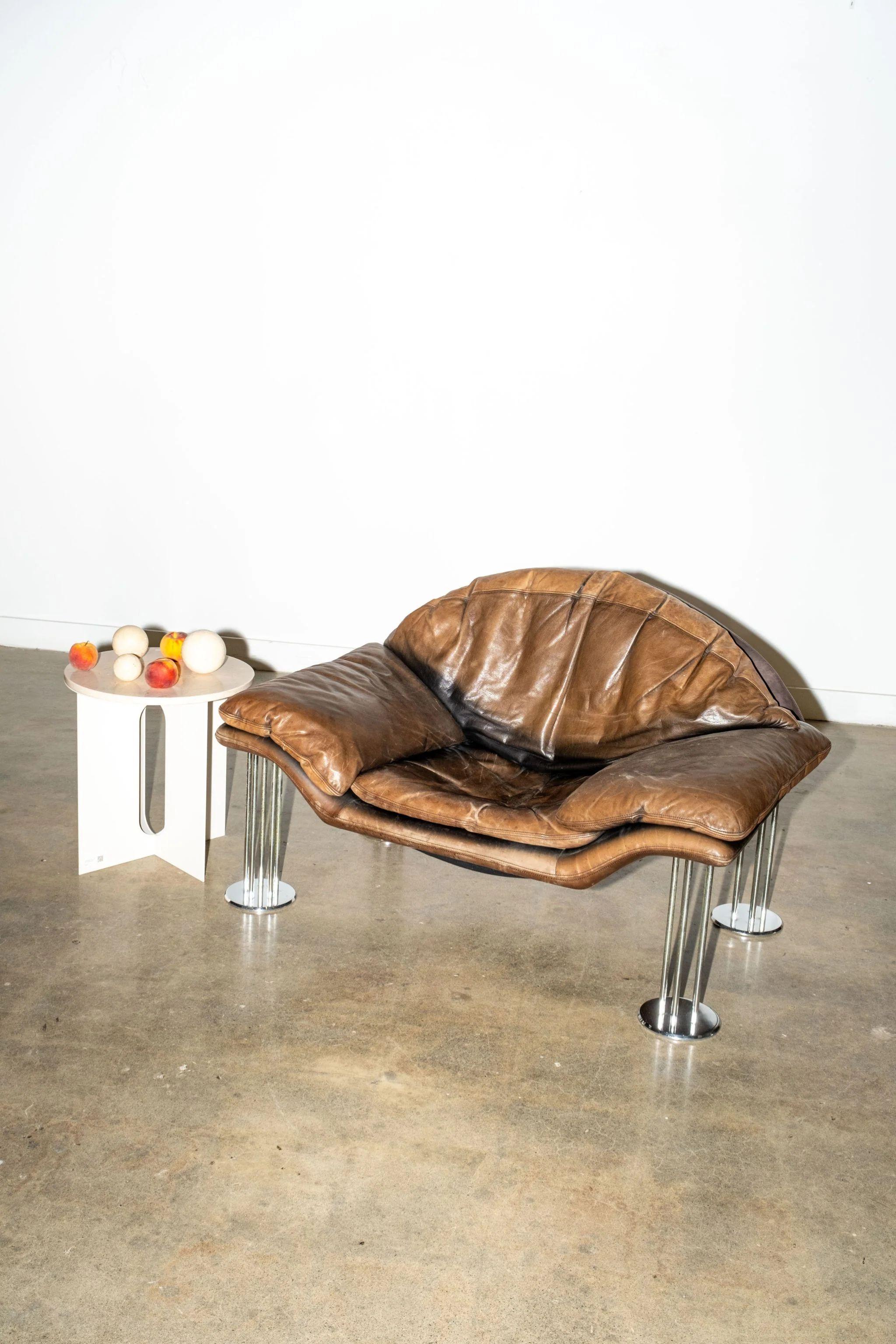Leather armchair by celebrated German furniture designer Burkhard Vogtherr (1942 – 2019). Dating from the eighties, this piece subtracts the bulk of traditional armchairs, using filament-like supports to create a sense of airiness. It feels typical