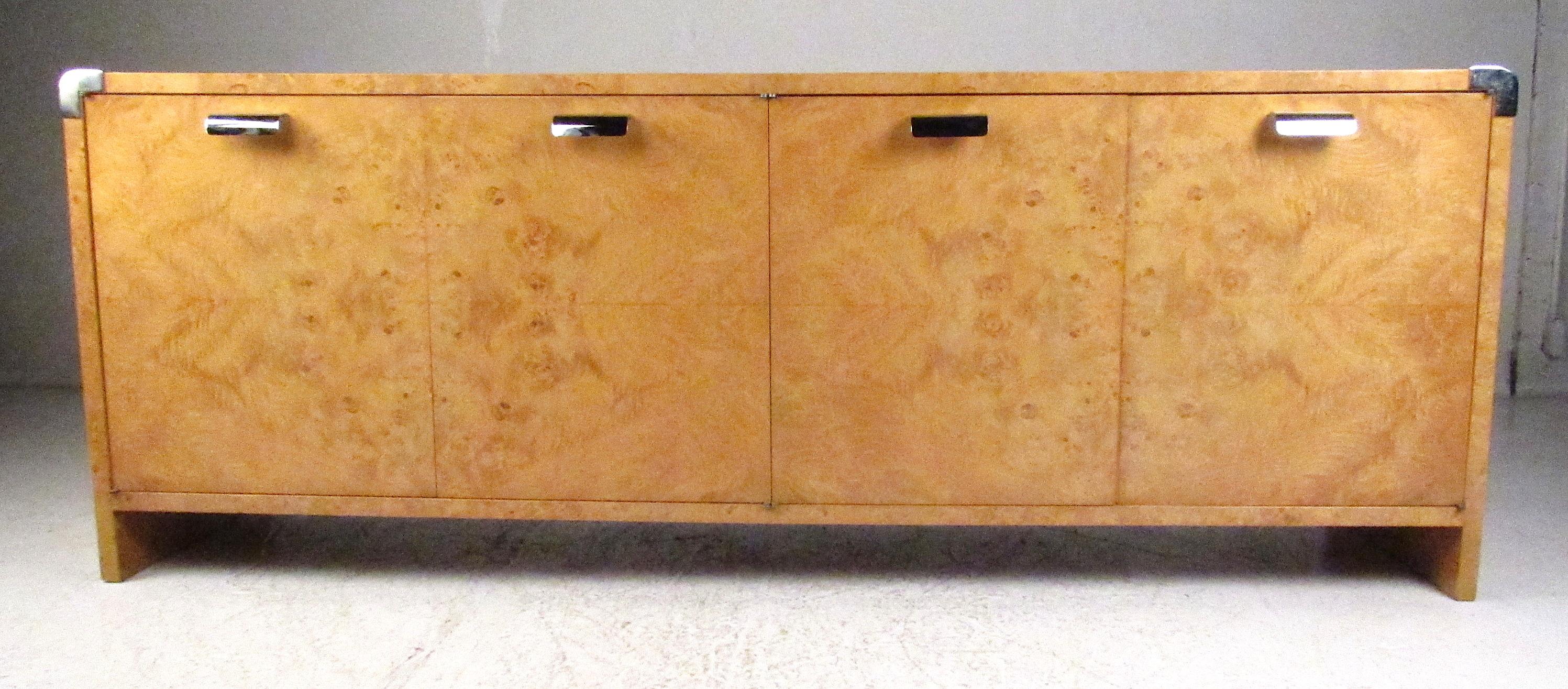 Beautiful four-door burl wood maple credenza with chrome accents in the style of Milo Baughman. One adjustable shelf on the left with three tray-storage drawers on the right make this a very functional and attractive storage option. Please confirm