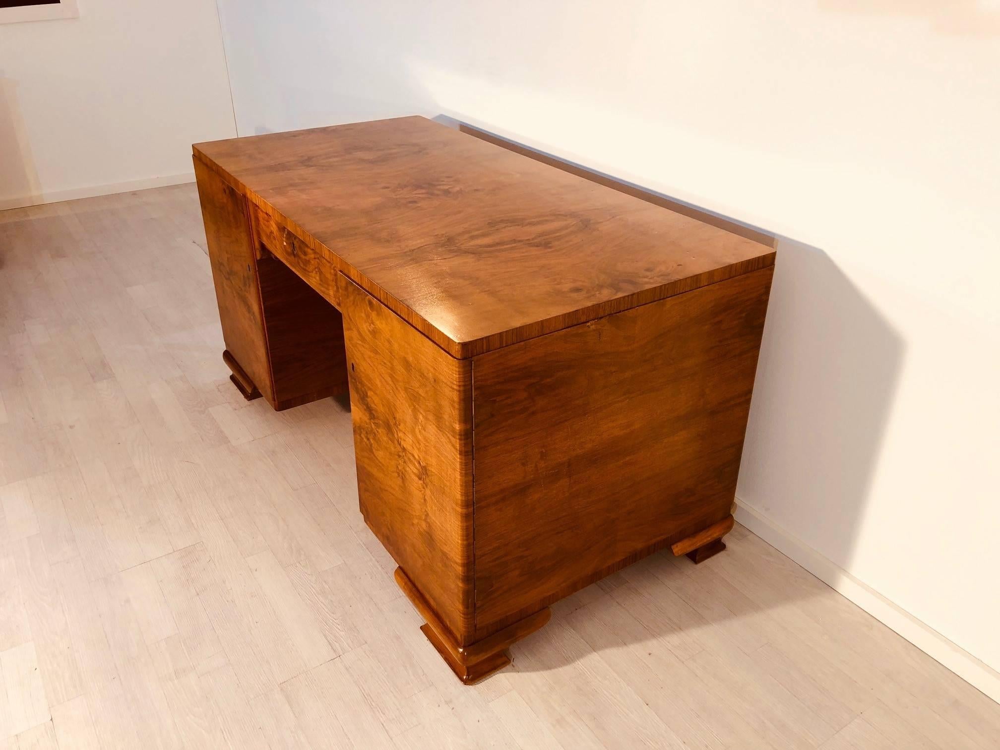 Amazing Art Deco burl desk made of wonderful walnut wood. Art Deco design meets uniquely grained wooden veneer. This French masterpiece offers storage space in fife drawers and convinces with great, high gloss polished tabletop.

 - Original French